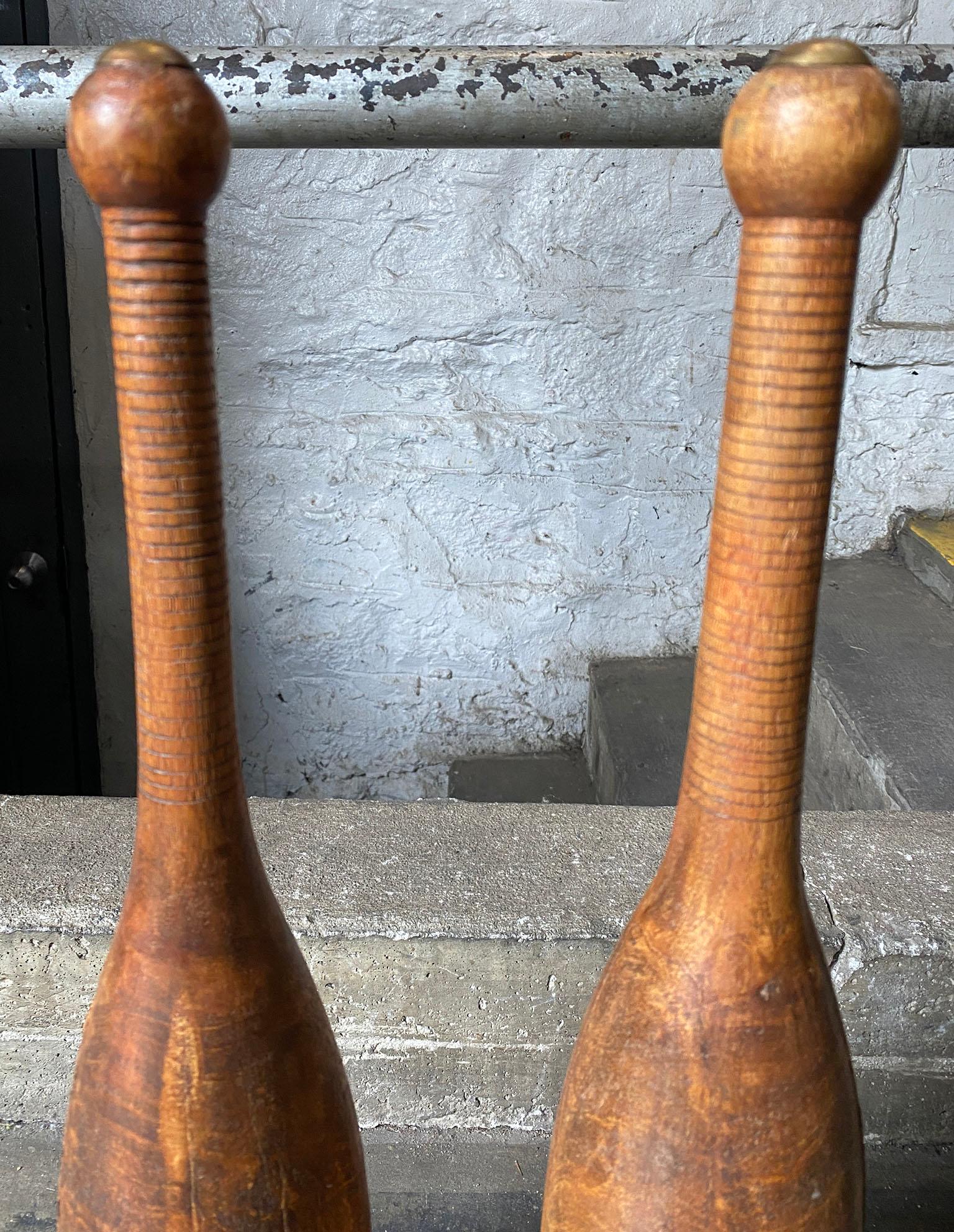 Beautiful juggling pin pair of hand turned wooden with brass cap. Amazing patina. Great decoration.