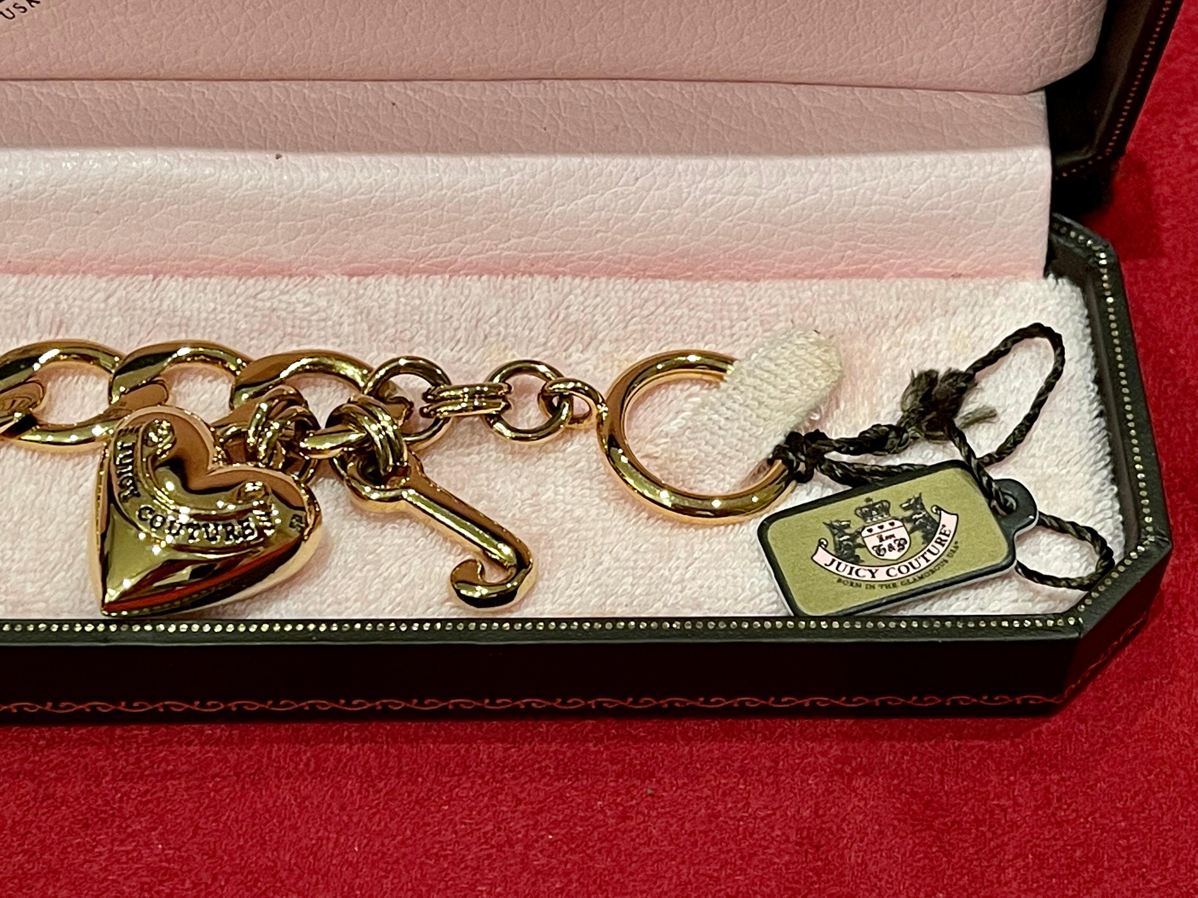 JUICY COUTURE bracelet in gold metal with two hooked charms, a 