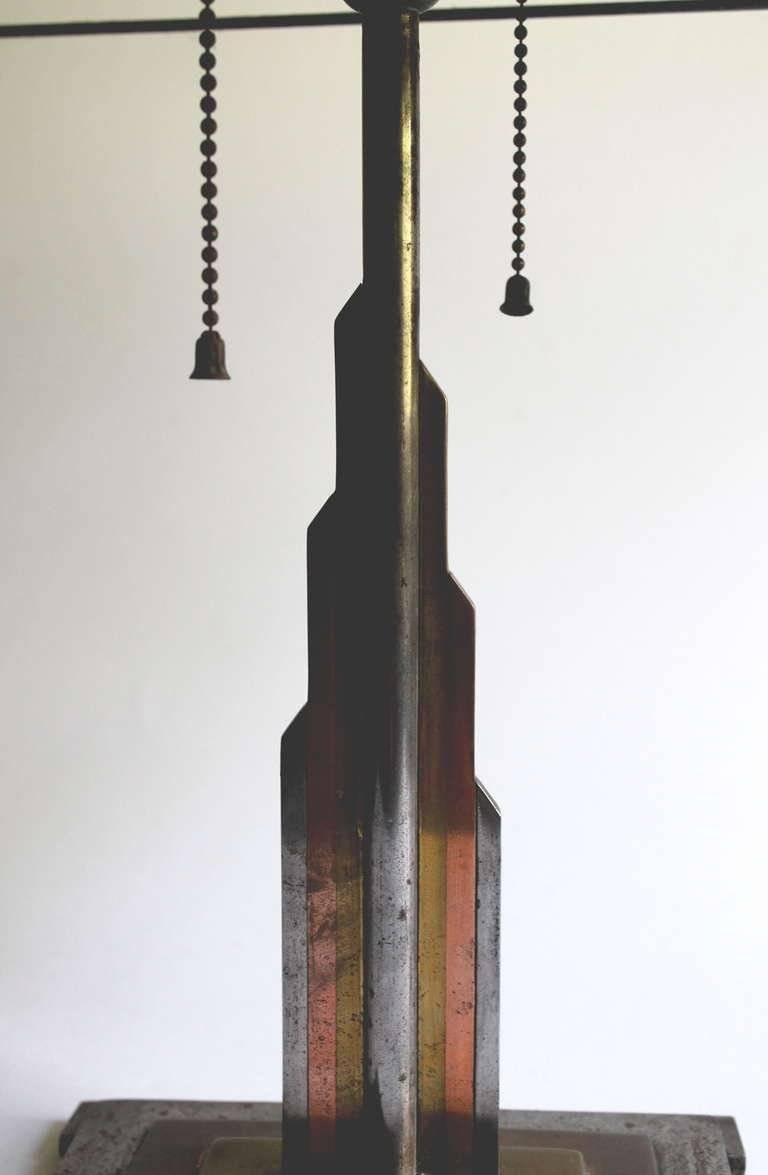 Eine Tischleuchte aus drei Metallen: Messing, Kupfer und Stahl, mit einem bemalten Glimmerschirm (auf der Seite verloren). Der moderne Amerikaner  dekorateur Jules Bouy (1872-1937), um 1925. H. 19