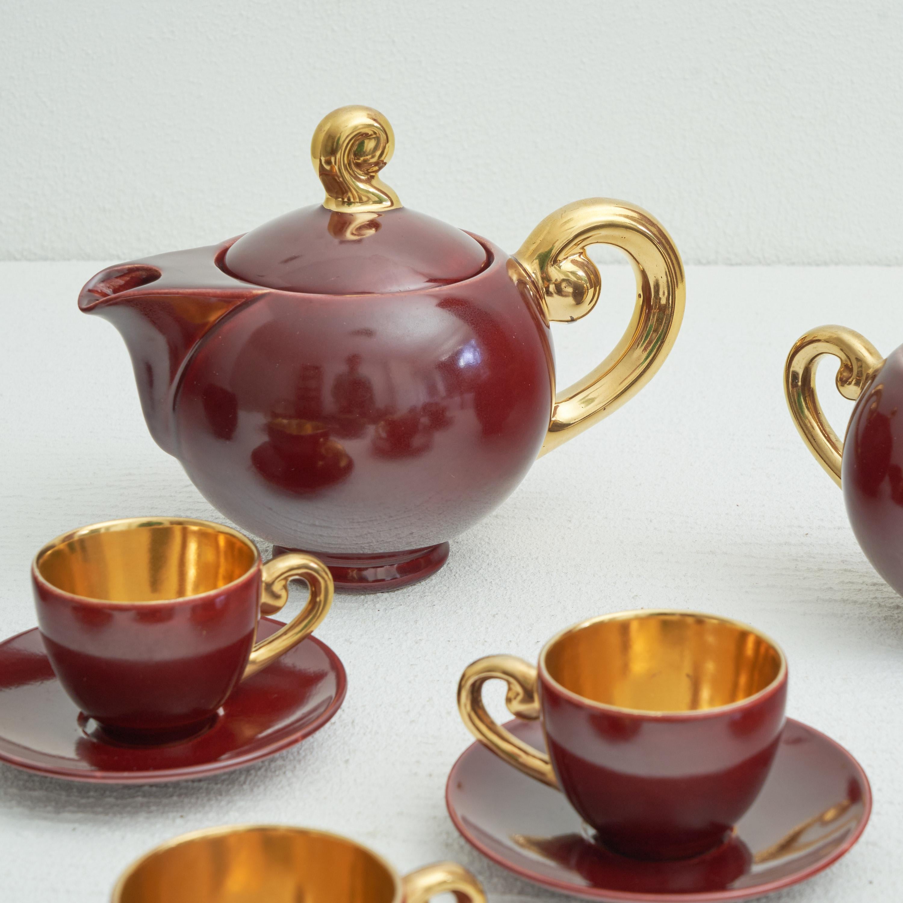 Jules Guérin 'Sang de Boeuf' and Gold Belgian Studio pottery coffee set. Bouffioulx, Belgium, 1960s. 

This is a wonderful and rare coffee set by the famous pottery workshop Guérin, at that time under guidance of Jules Guérin - the son of Roger