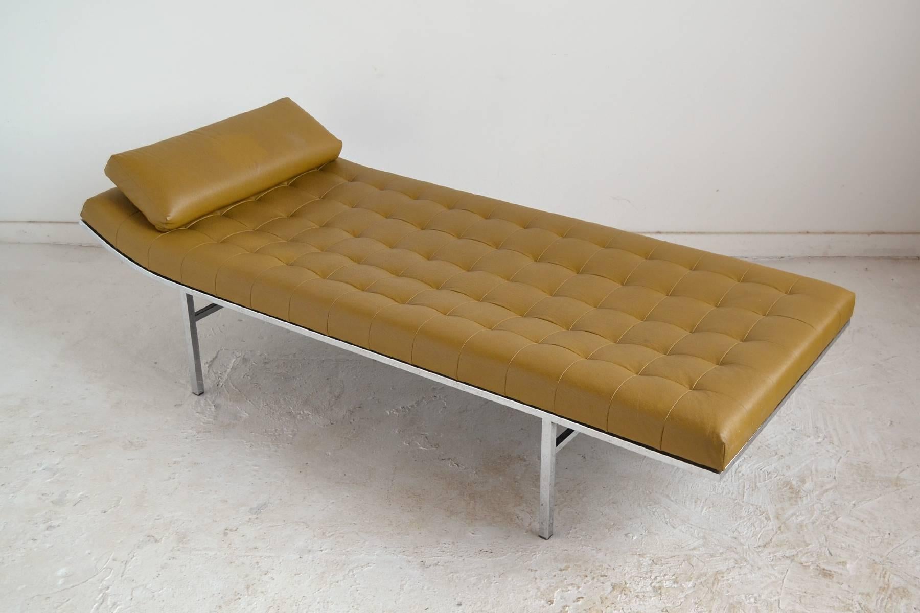 An elegant and extremely comfortable design, this chaise or daybed by Jules Heumann for Metropolitan has a long, low upholstered body with box tufting and a slightly raised end supported by a chromed steel frame. A loose cushion provides additional