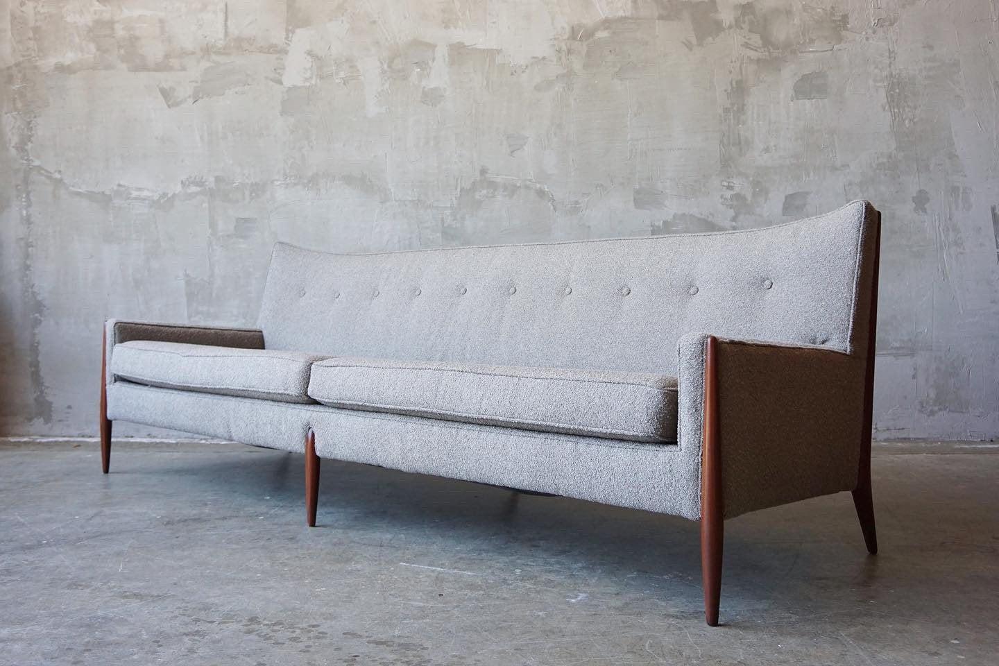 Beautifully designed and crafted sofa by Jules Heumann for Metropolitan Furniture, circa 1960s.

Featuring sculpted walnut legs and covered in a warm grey bouclé. 

Excellent condition as photographed. 

Measures: 92” W x 31” D x 31.5”