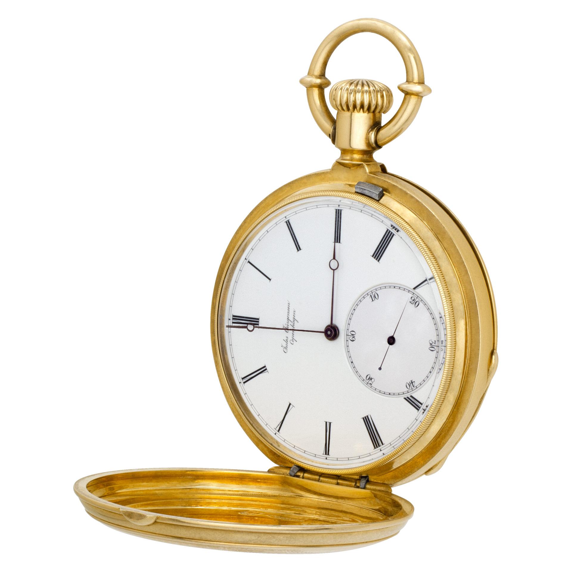 Jules Jurgensen hunter case pocket watch with porcelain dial and moon hands in 18k yellow gold . Barley corn engine turned front and back lid. Manual 18 jewel movement w/ subseconds. Patented bow set. 54.5mm case size. Circa 1890s. Fine Pre-owned