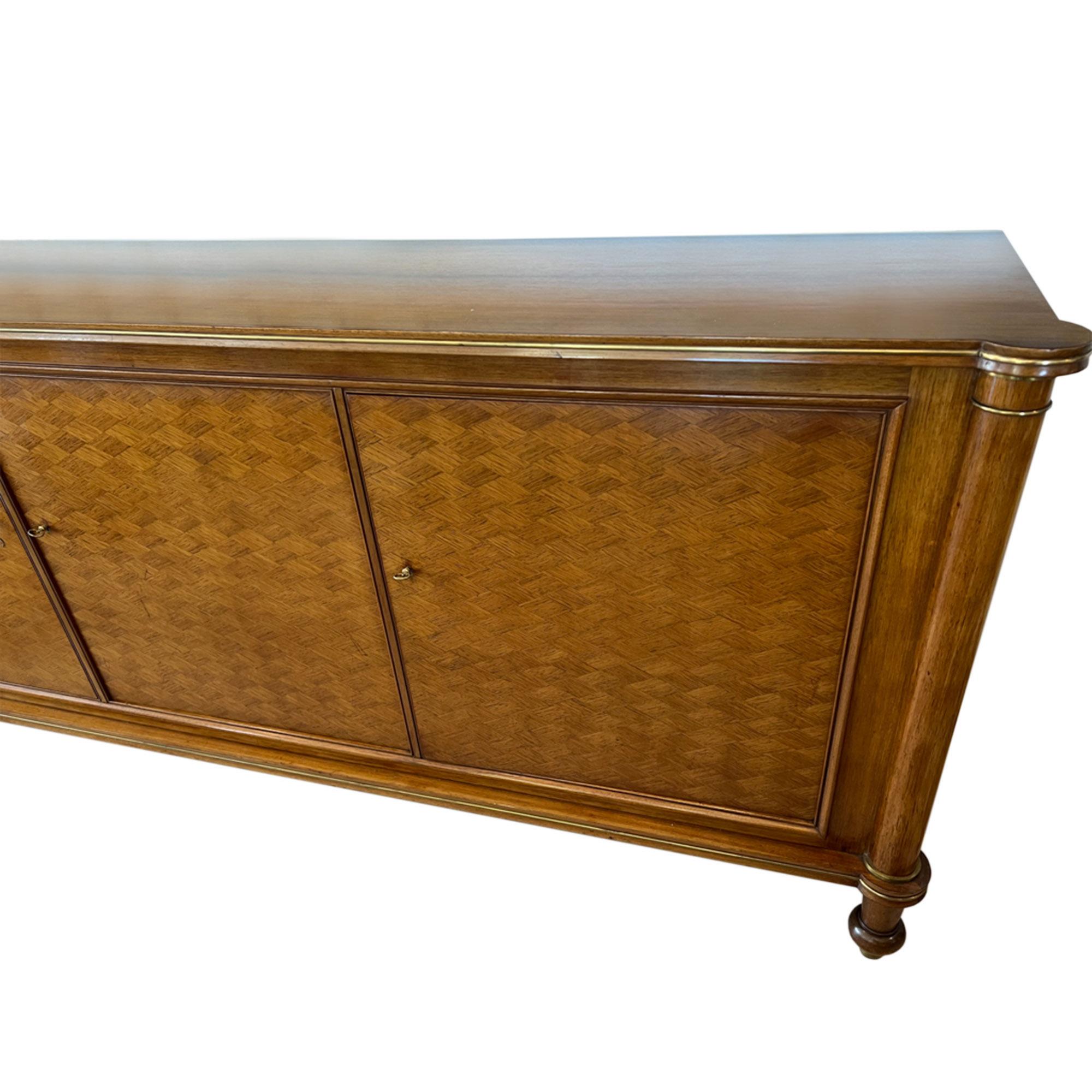 A beautiful sideboard designed by Jules Leleu. This piece still retains the original paper label on the back, stating the serial number, it's signed and dated 1956. 

This piece has 3 diamond lozenge pattern parquetry doors, with column supports