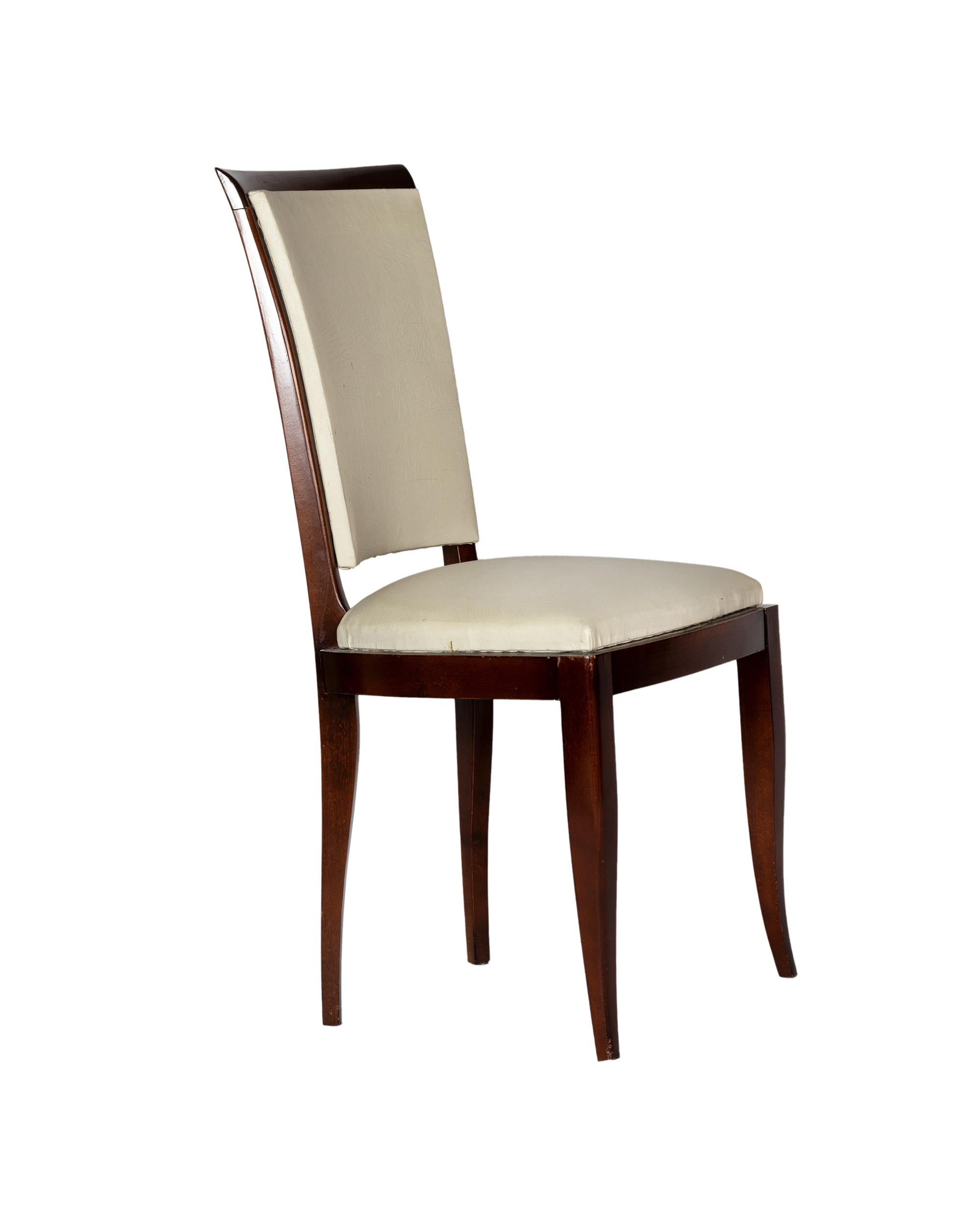 A very elegant set of six dining room chairs in white vinyl and polished wood finish.  In excellent condition, recently revised by an expert ebanist.