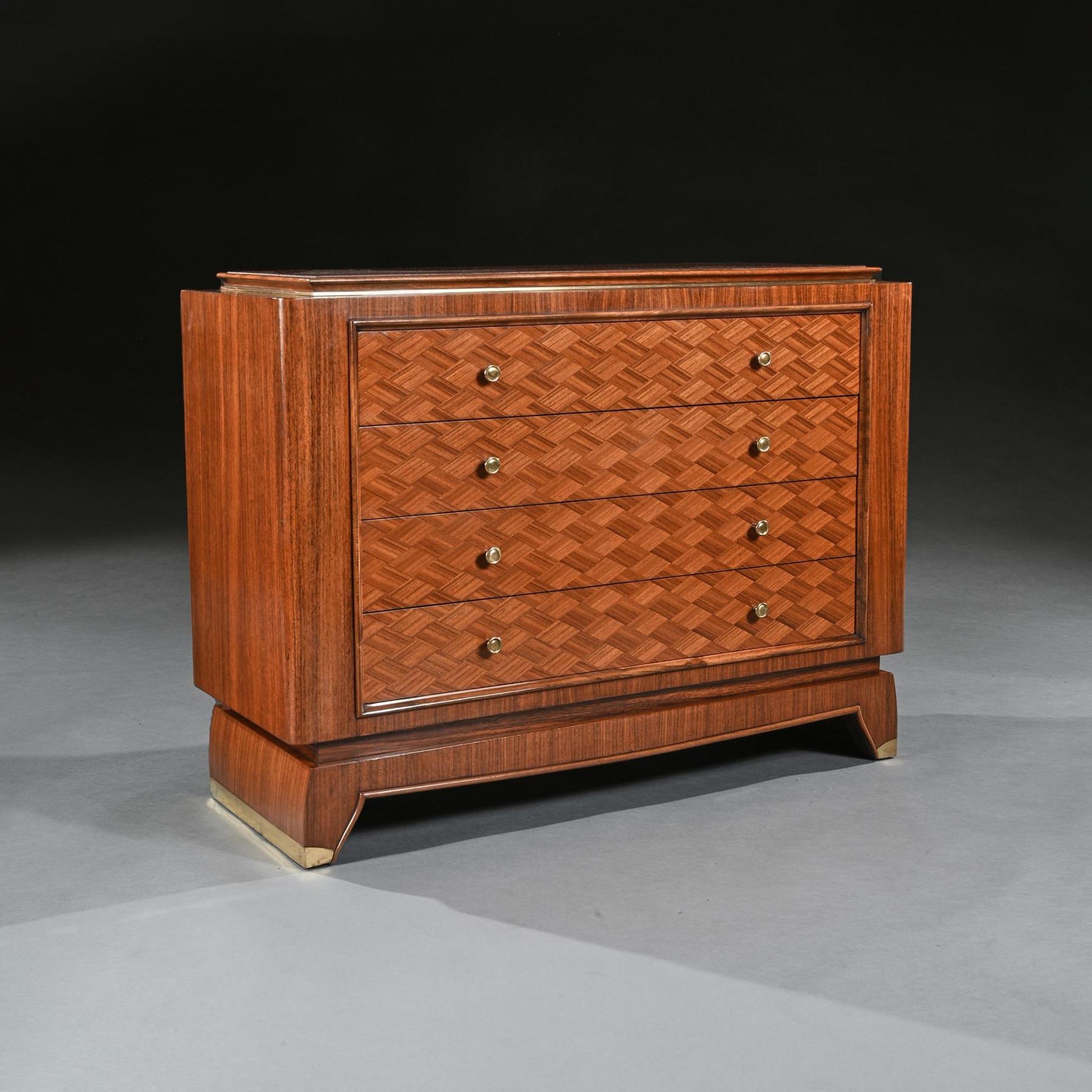 Rare French Art Deco walnut commode firmly attributed to Jules Leleu (1883-1961).

French, Paris circa 1930.

Wonderfully constructed as one would expect, the moulded and in-stepped oblong top above four lozenge parquetry-veneered long drawers
