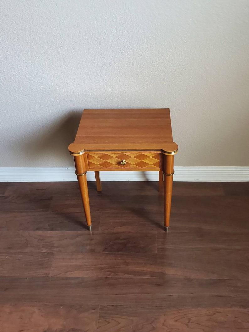 A rare French Art Deco sycamore inlaid nightstand or end table attributed to Jules Leleu (1883-1961). Handcrafted in France in the mid 20th century, having a shaped front rectangular top, above a single dovetailed drawer with parquetry inlay drawer