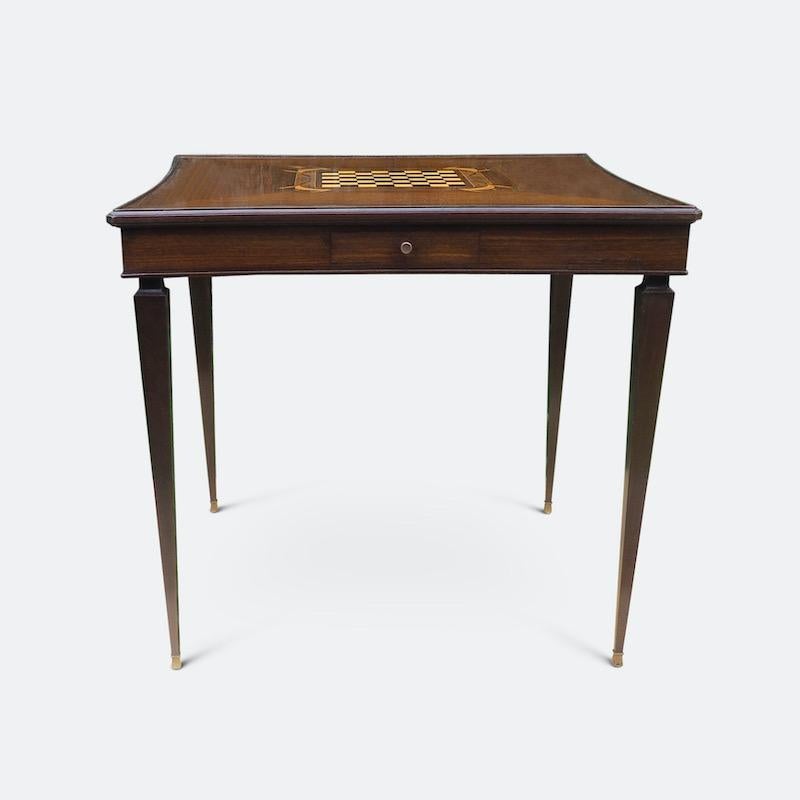 A luxurious Marquetry card and games table by Jules Leleau of Paris with an inlaid sycamore and ebony chess board surrounded with scrolls and swags of exquisite craftsmanship. The sinuously crafted fruitwood tabletop flips to reveal a fawn baize