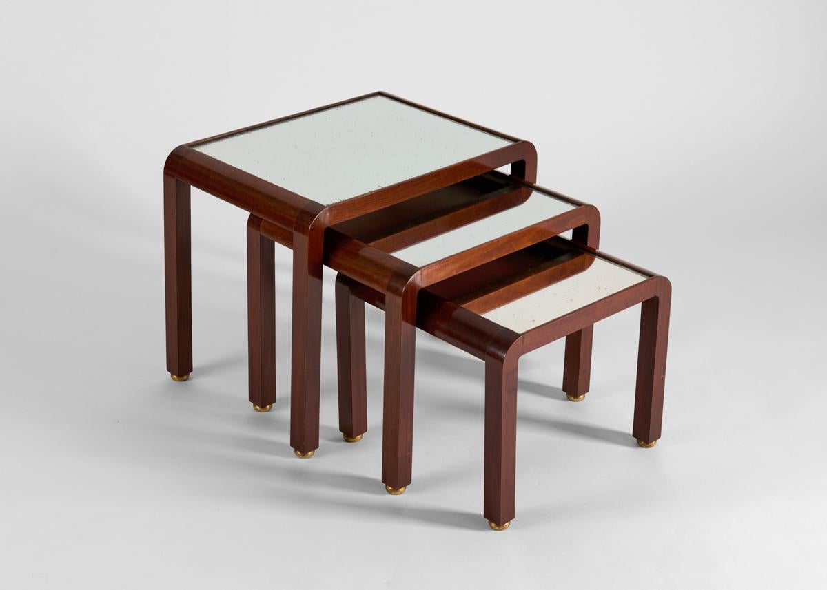 A set of post-war mirror-topped nesting tables in polished mahogany by Deco icon Jules Leleu.

Leleu. Françoise Siriex, Monelle Hayot. Château de Saint-Remy-en-l'Eau, 2007. An identical series reproduced page 45.

Numbered and stamped.