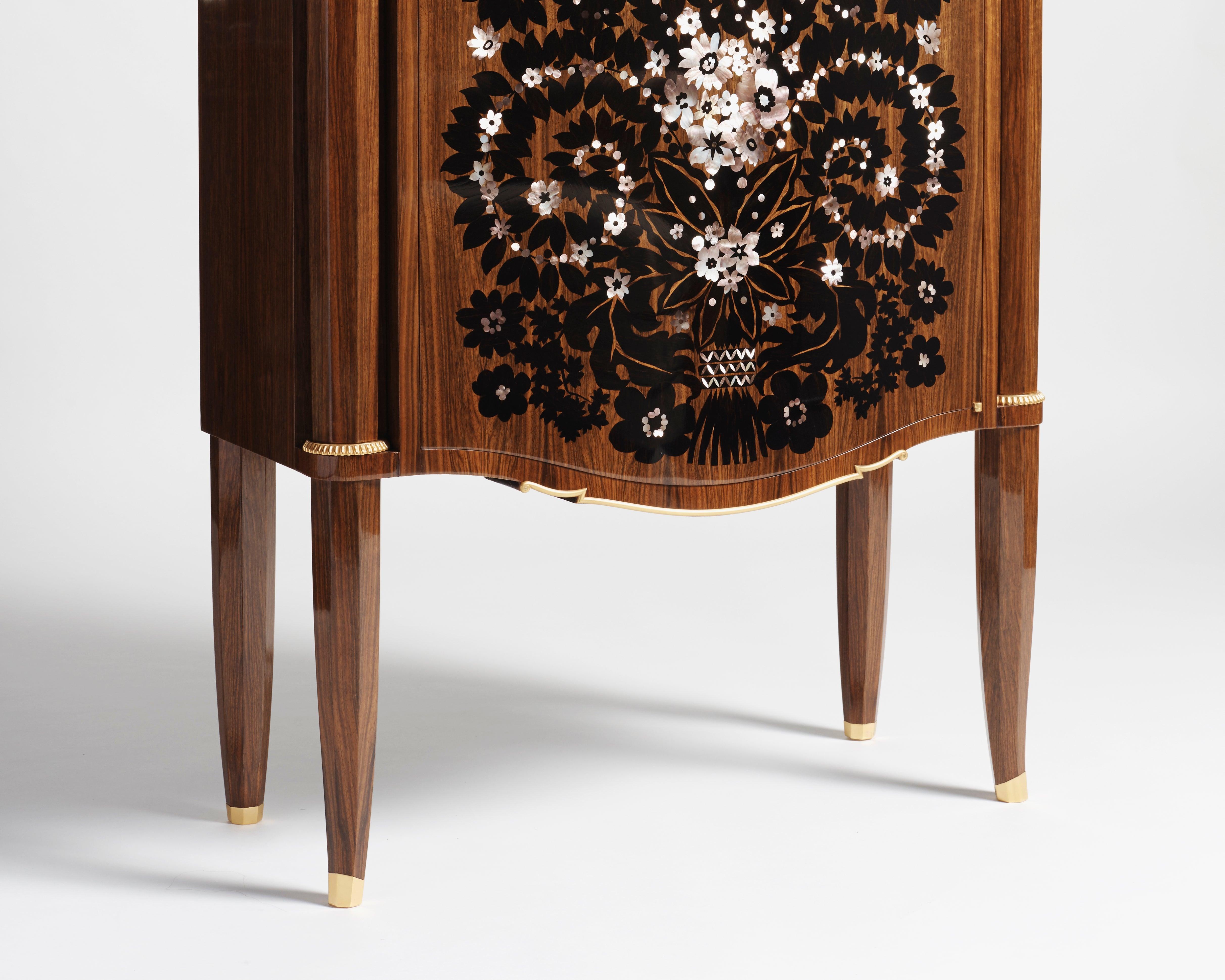 An exceptional, rare mahogany cabinet made by Jules Leleu the year after the war, featuring gilt bronze details and ornaments, and an elaborate, mother of pearl and ebony inlay by Messager.
