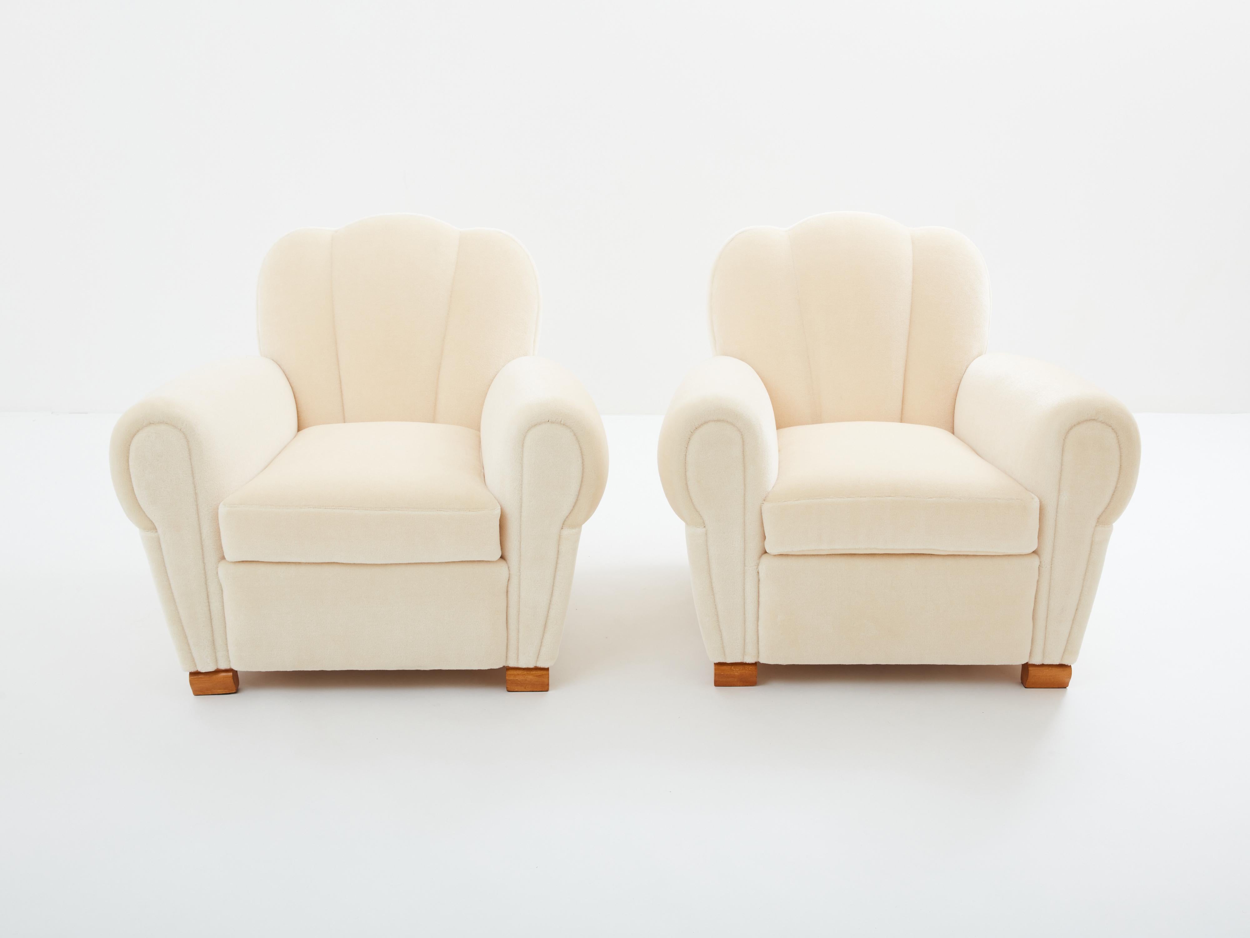 This beautiful pair of armchairs designed by Jules Leleu around 1945 embodies the smooth lines of the art deco club chairs that came on the market in the early 1930s. The smooth and round lines are a thing of beauty, finished with curved oak feet,