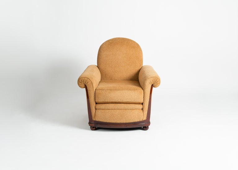 This plush armchair is an early creation of Art Deco icon Jules Leleu, and features a mahogany frame, rounded sabots, and spiraled arms.

Numbered on frame.