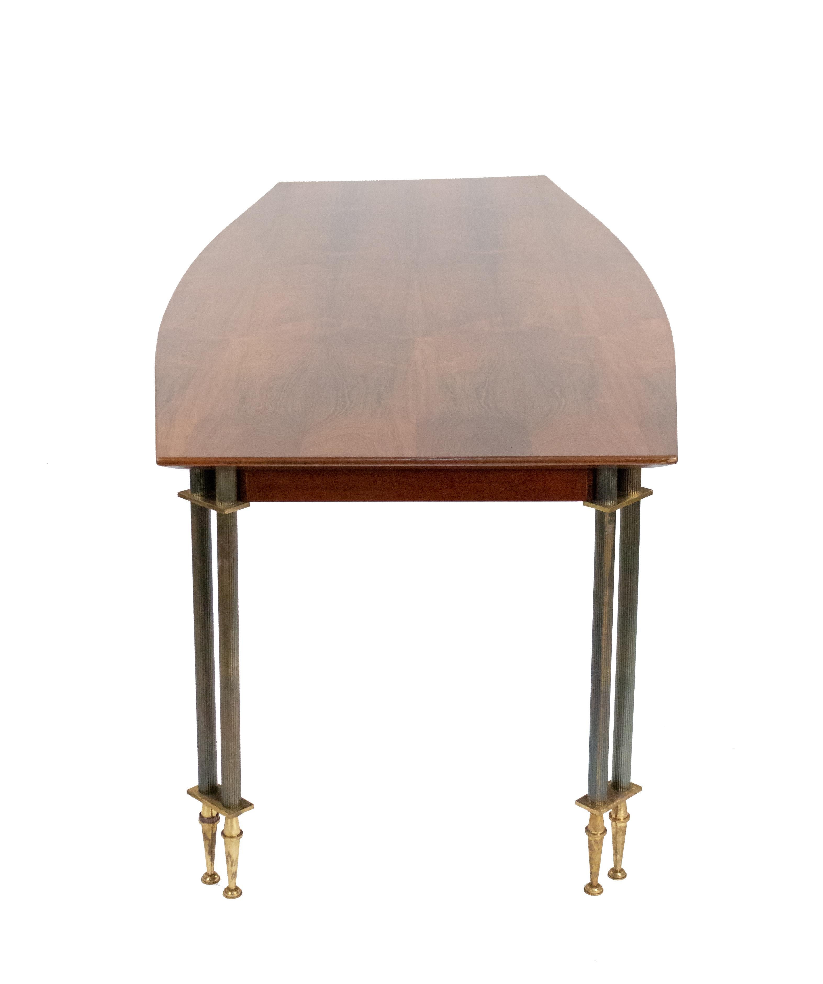French midcentury rosewood dining table with a gently bowed top and chamfered edge on double fluted bronze legs with gilt sabots (signed: J Leleu; model N4991, 1958).
