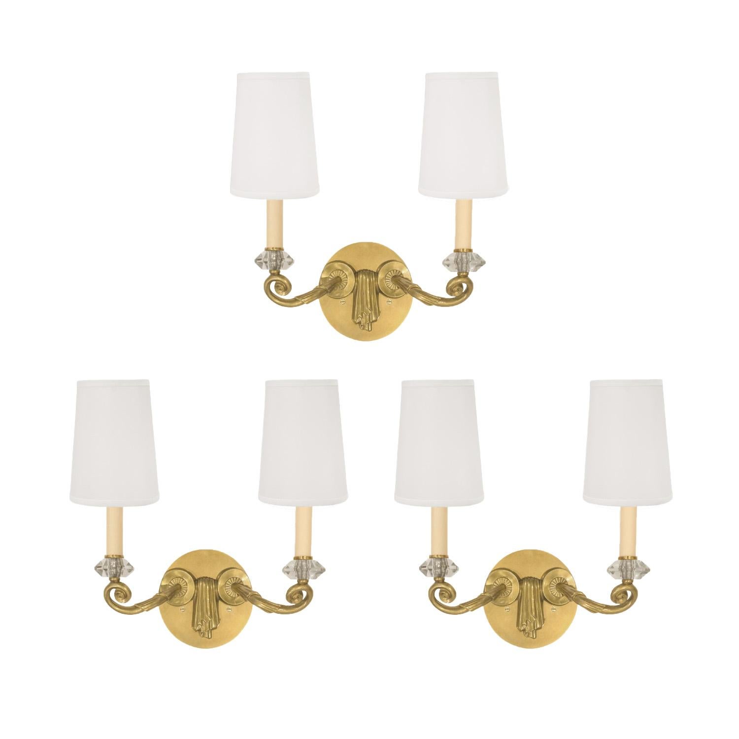 Set of three sconces model no. 3626 in bronze with faceted glass crystals by Leleu, France c.1948 (stamped “LELEU PARIS” on back). These sconces have been restored and newly rewired and take standard candelabra bulbs. These iconic sconces are the