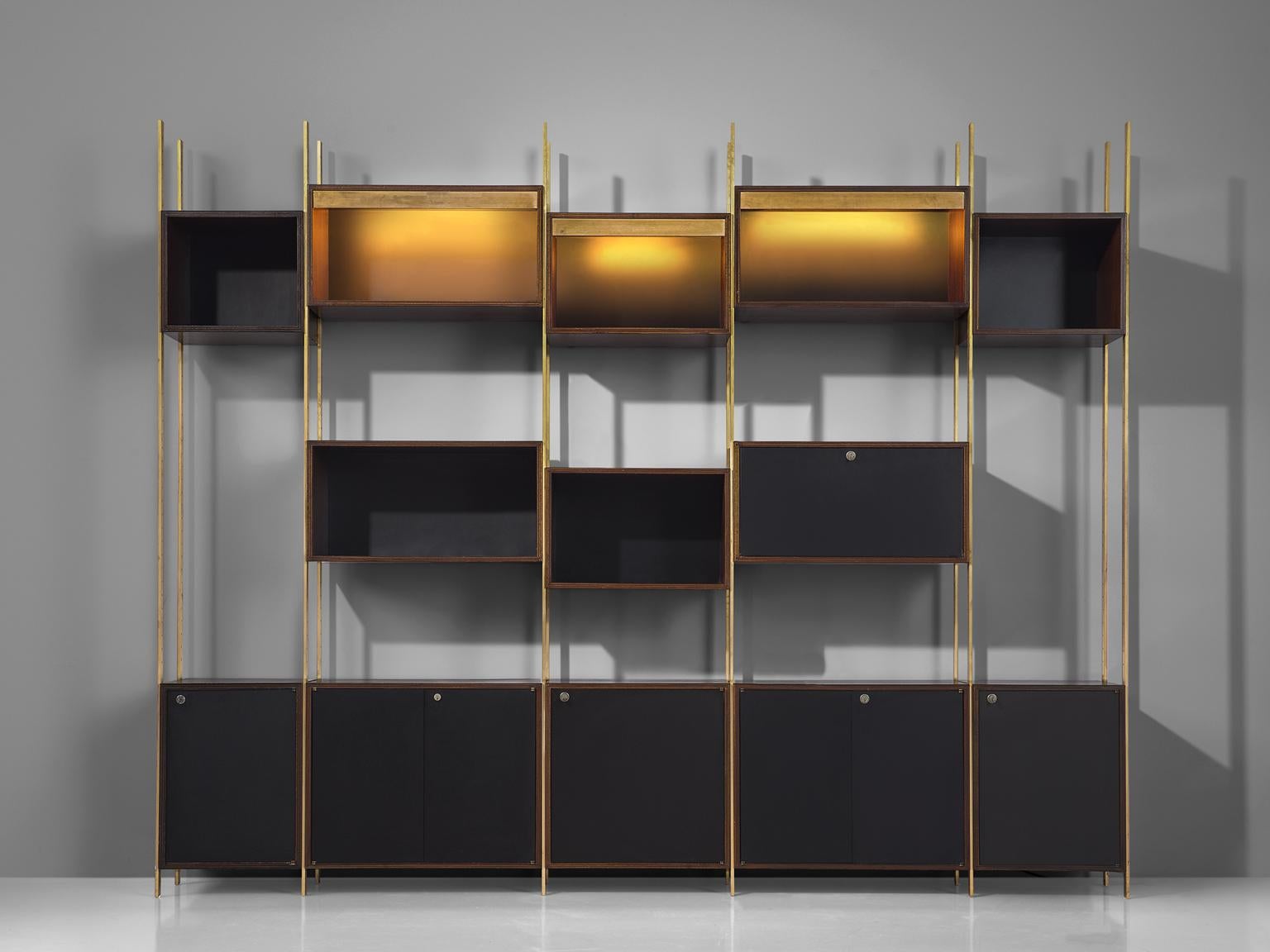 Jules Wabbes for Mobilier Universel, Bookcase, in brass and rosewood, Belgium, 1960s.
 
Rare wall unit designed with the highest precision in furniture making by master furniture-maker Jules Wabbes. This exceptional piece could be used as a library
