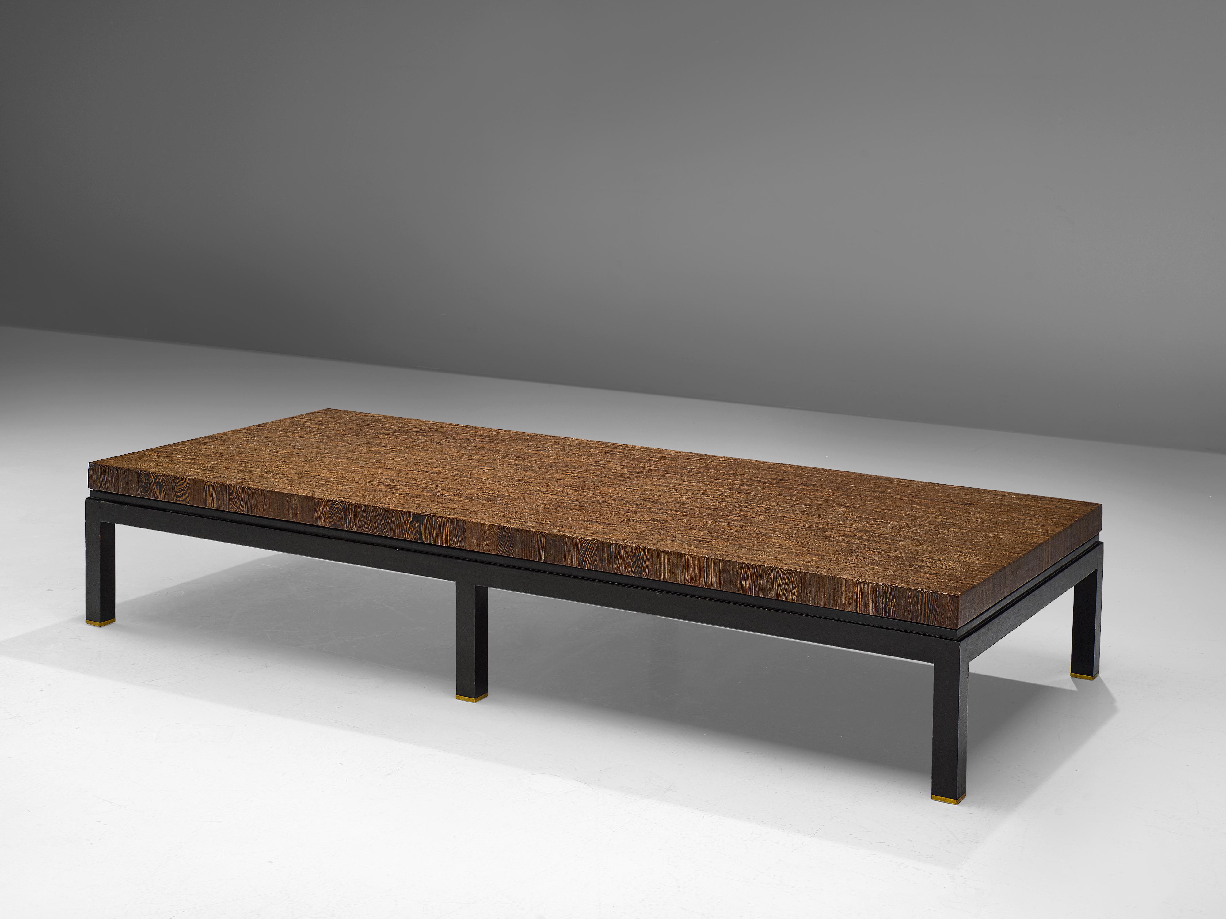 Jules Wabbes, extra large and custom made coffee table, wengé, steel, brass, Belgium, 1970s

Jules Wabbes designed this custom made large coffee table in the 1970s. The tabletop owns its intricate appearance due to the use of the end-grain wood