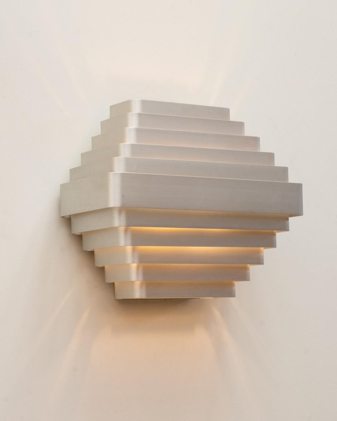 Large wall lamp by the belgian designer Jules Wabbes , dating back to circa 1970
 It features 11 aluminum strips ...  a great light effect and  a warm illumination.
This wall lamp is an original vintage piece,  all in remarkably well-preserved