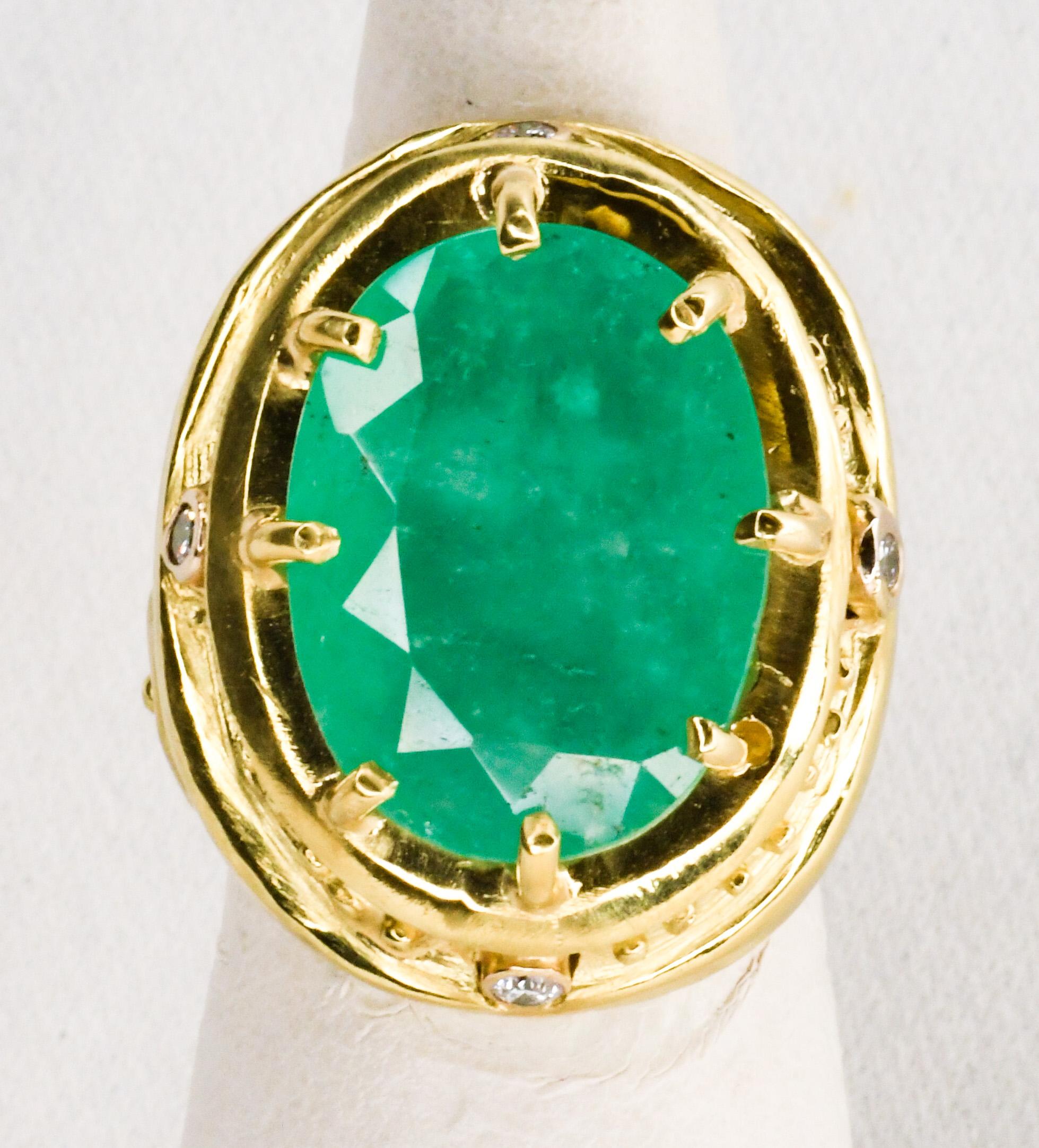 Evoking ancient civilizations, this handcrafted 18K yellow gold ring boasts an oval 20 carat emerald sourced from Colombia and approximately 20 pts of round white diamonds.  Appropriately hallmarked and signed 