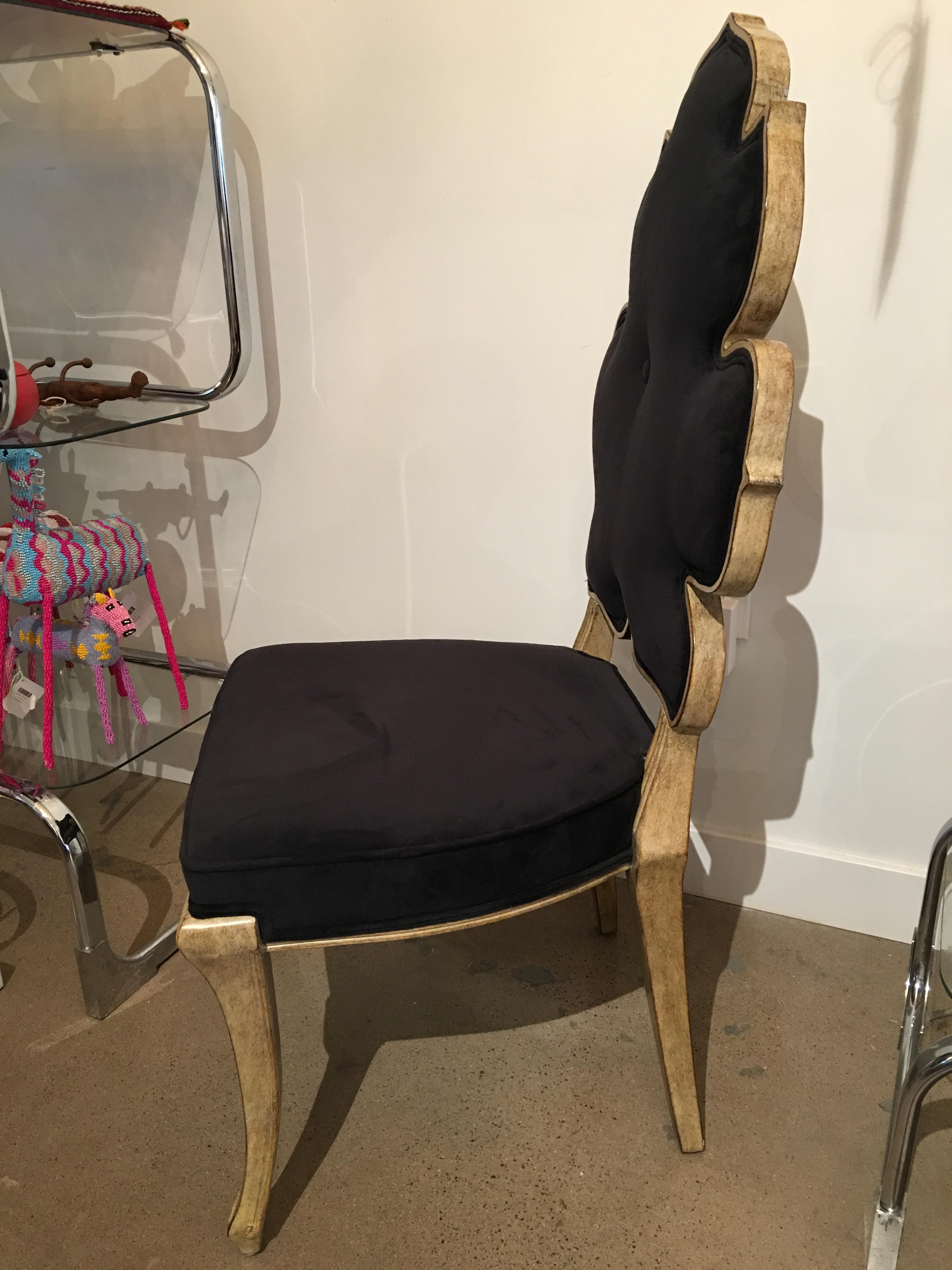 This chair designed by Julia Buckingham has a royal vibe and a feminine charm. The dining table/armless version is perfect for any style of dining room table as it fits right in with a whimsical note. Chair is upholstered in black nylon velvet.