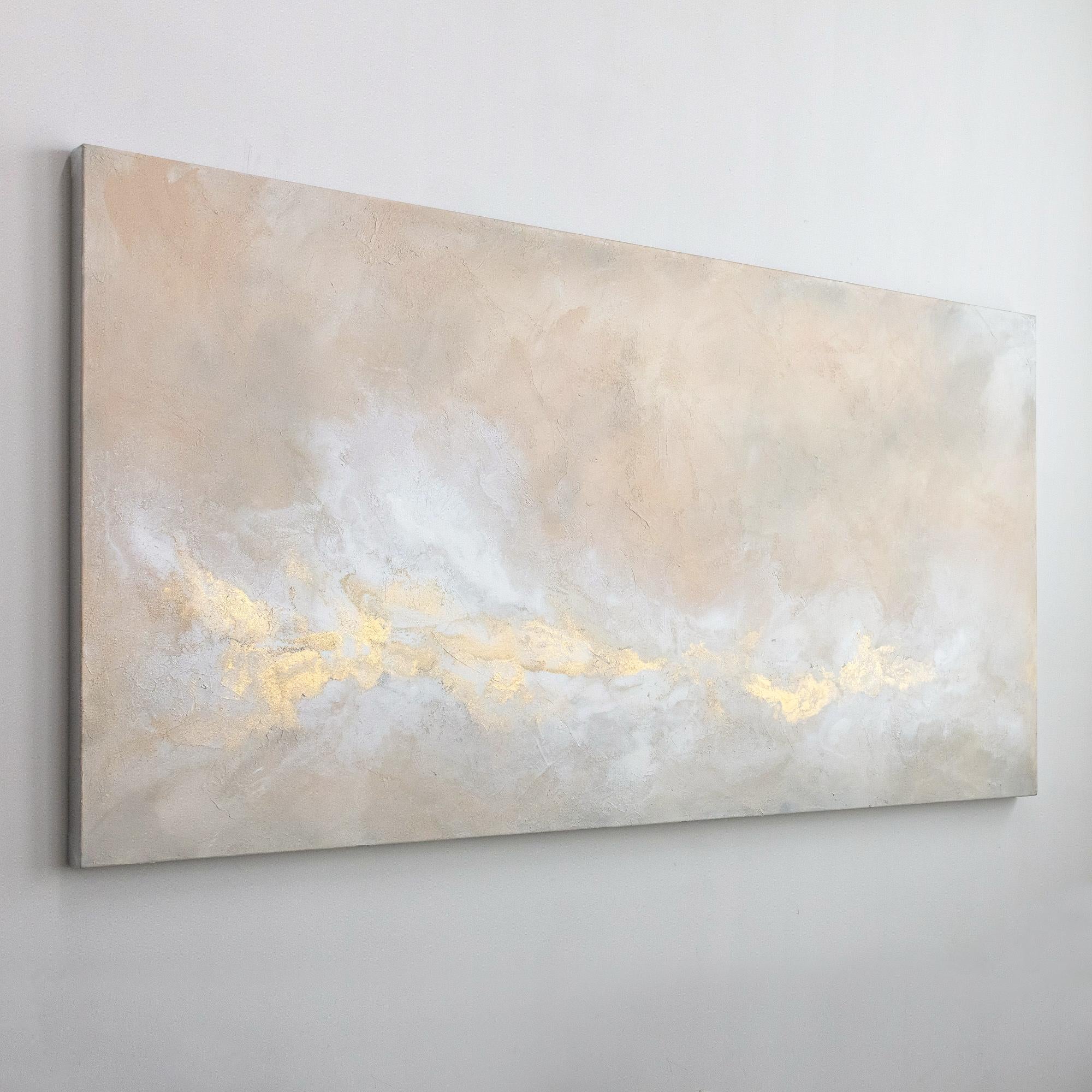 This large abstract statement painting by Julia Contacessi is made with mixed media on canvas. It features a light, balanced composition and a warm neutral palette with blush tones, white, and metallic gold accents. The sides of the painting are