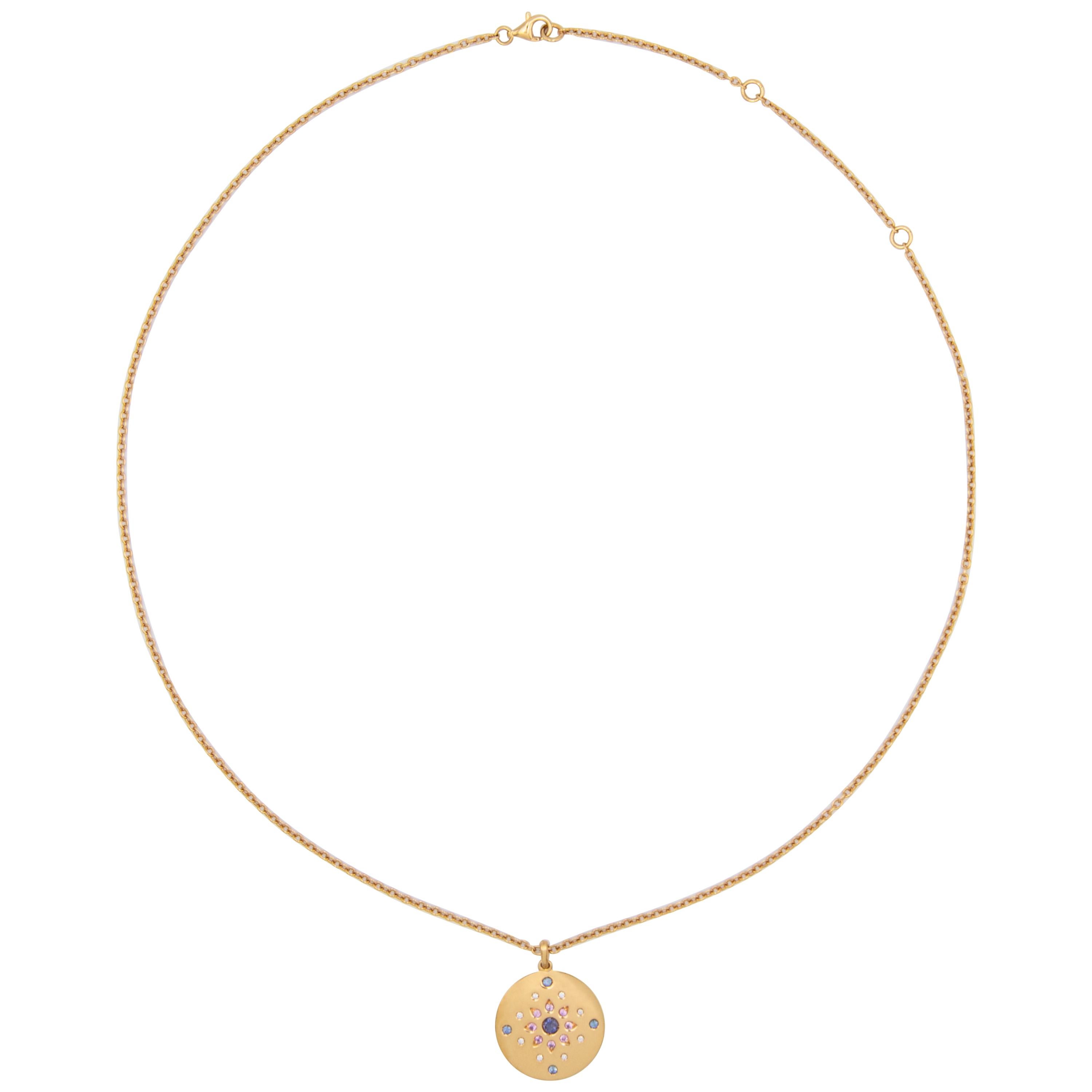 18 karat yellow gold necklace with round disc pendant and adjustable long chain. The pendant is set with 21 gemstones including a central iolite, 0,28-carat of blue and pink sapphires and 0,11-carat of diamonds. 

This is the longer chain option for