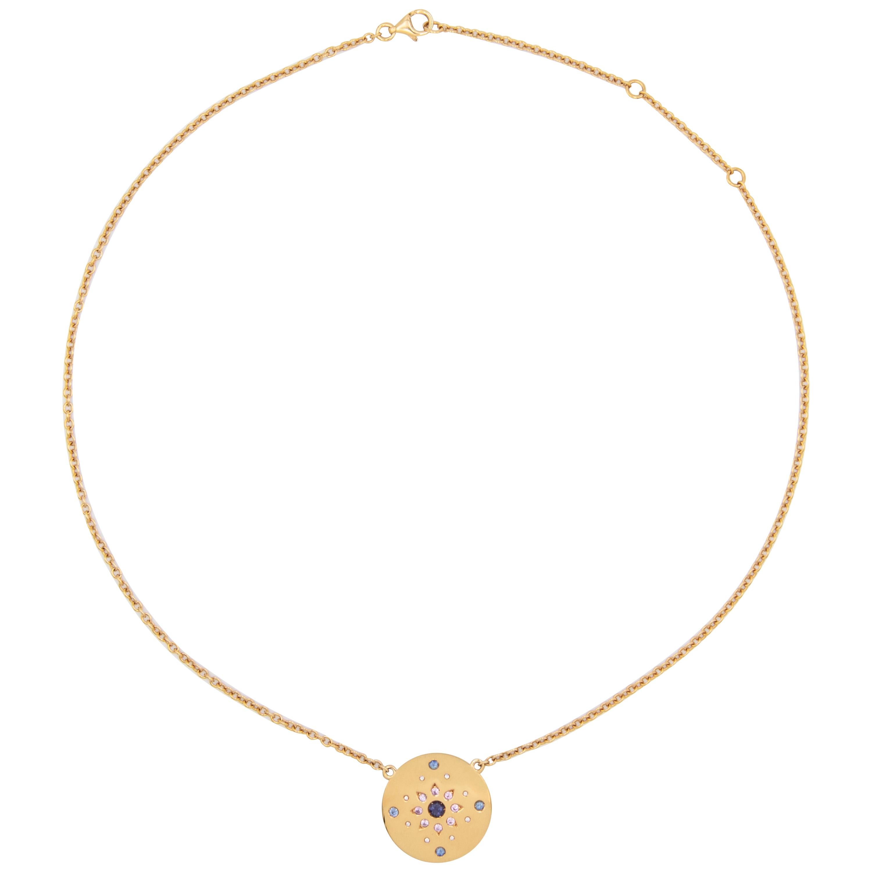 18 karat yellow gold necklace with round disc pendant and adjustable chain. The pendant is set with 21 gemstones including a central iolite, 0,28-carat of blue and pink sapphires and 0,11-carat of diamonds. 

This is the shorter chain option for