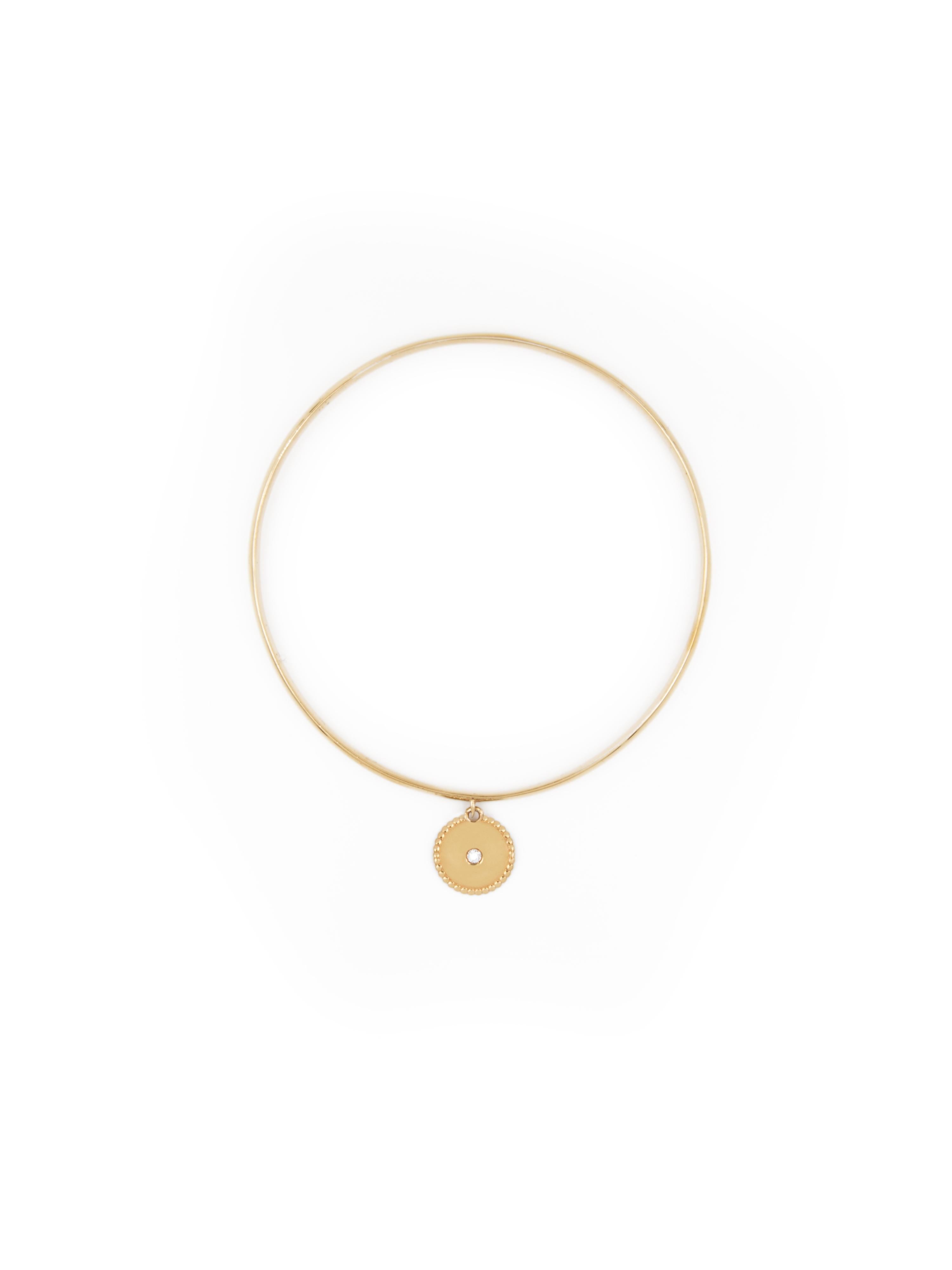 18 karat yellow gold bangle stacking bracelet with disc charm set with a 0,03-carat central diamond.
  
This bracelet is available in a standard diameter of 6,25 cm (2,46 inch), intended to fit most wrists.

Perfect worn alone or for stacking with