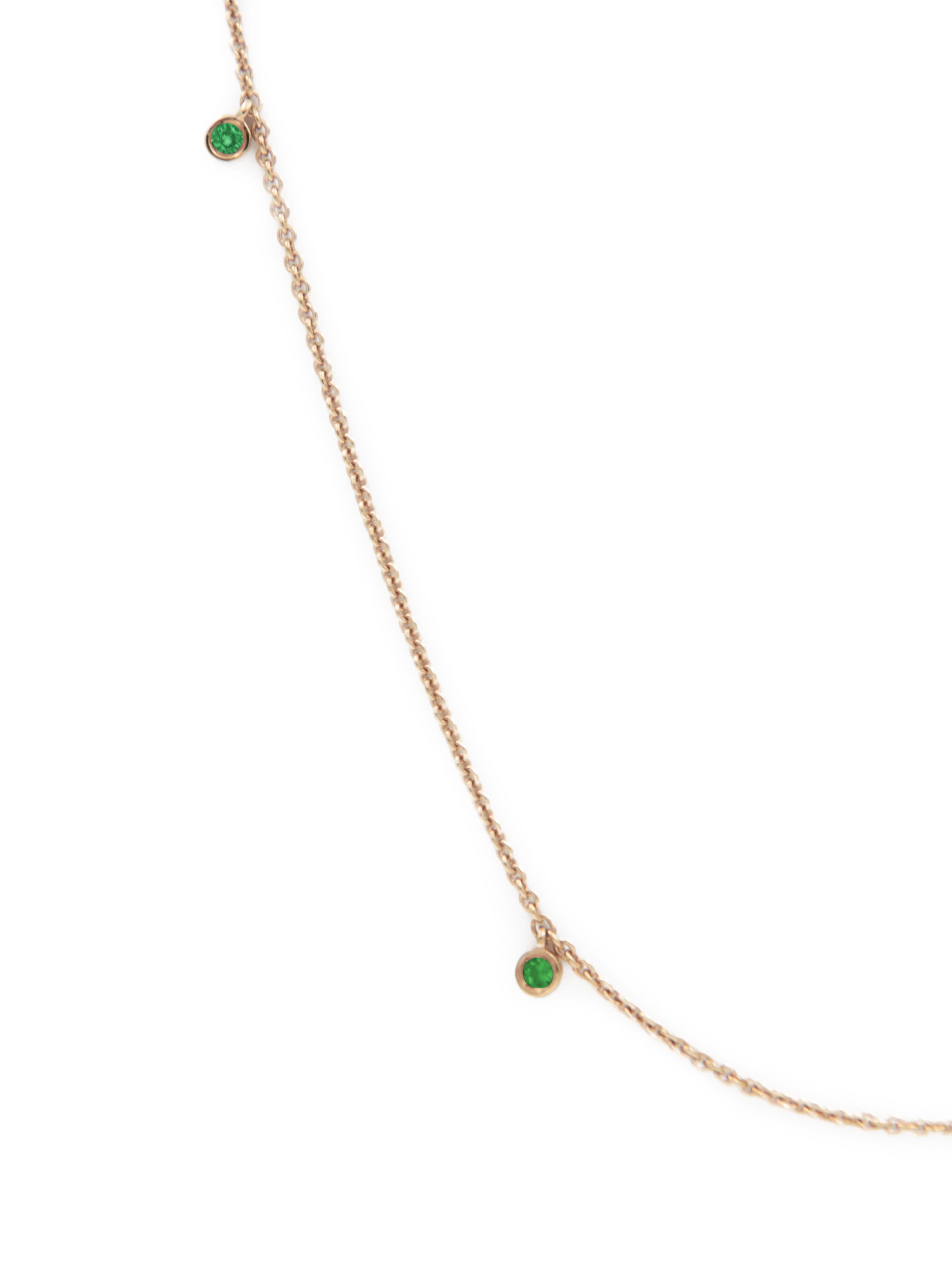 18 karat yellow gold necklace set with emeralds (0,24-carat). 

The chain is adjustable at a length of 42, 45 and 50 cm (16,5, 17,7 and 19,6 inch). 

Please note that the necklace described corresponds to the first and second pictures of this