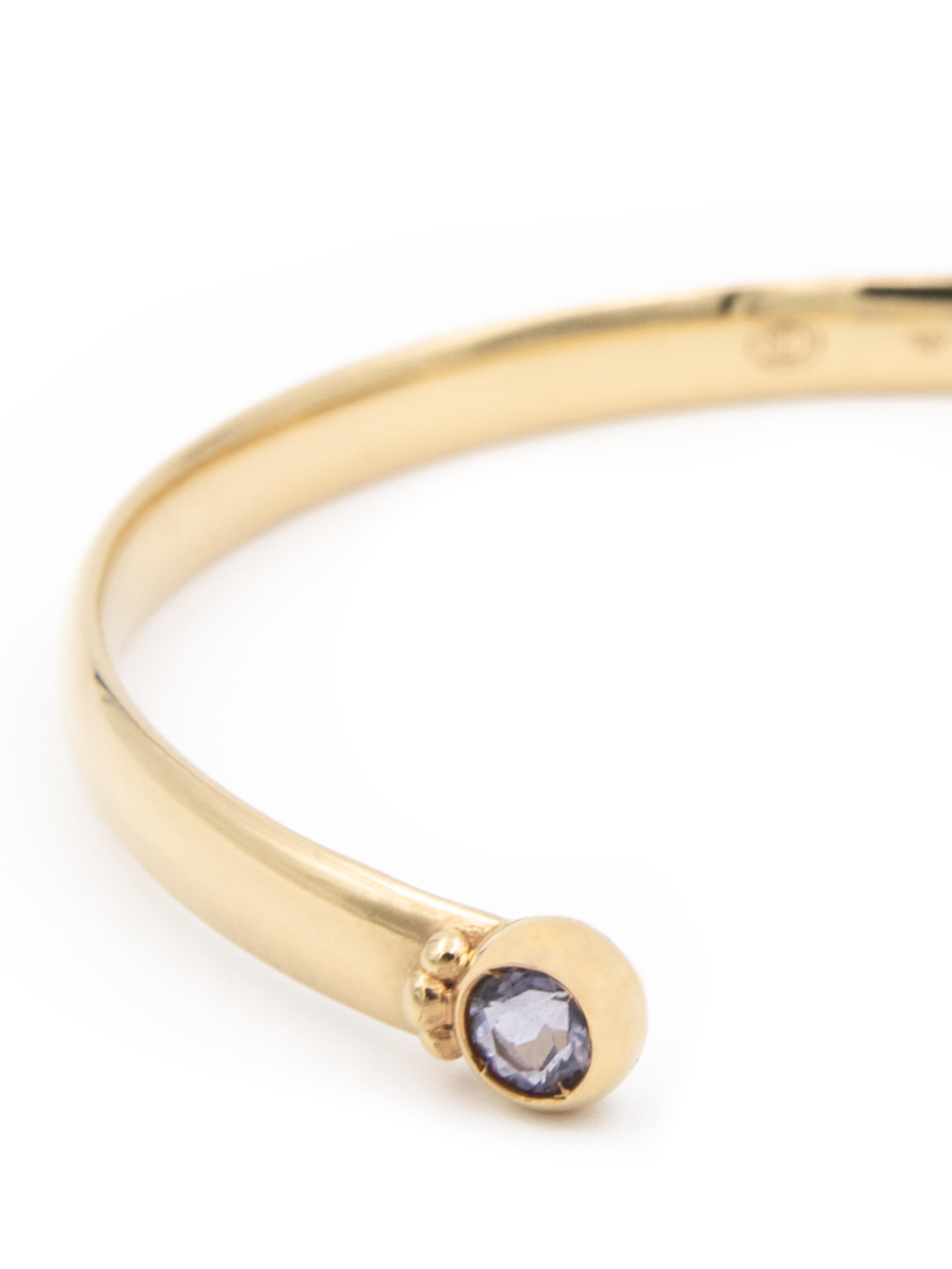 18 karat yellow gold open stacking bracelet with two round iolite stones measuring 4 mm each.  
  
Perfect worn alone or for stacking with the other stacking bracelets in the Mezzanotte Milano collection.

This bracelet forms part of Julia-Didon