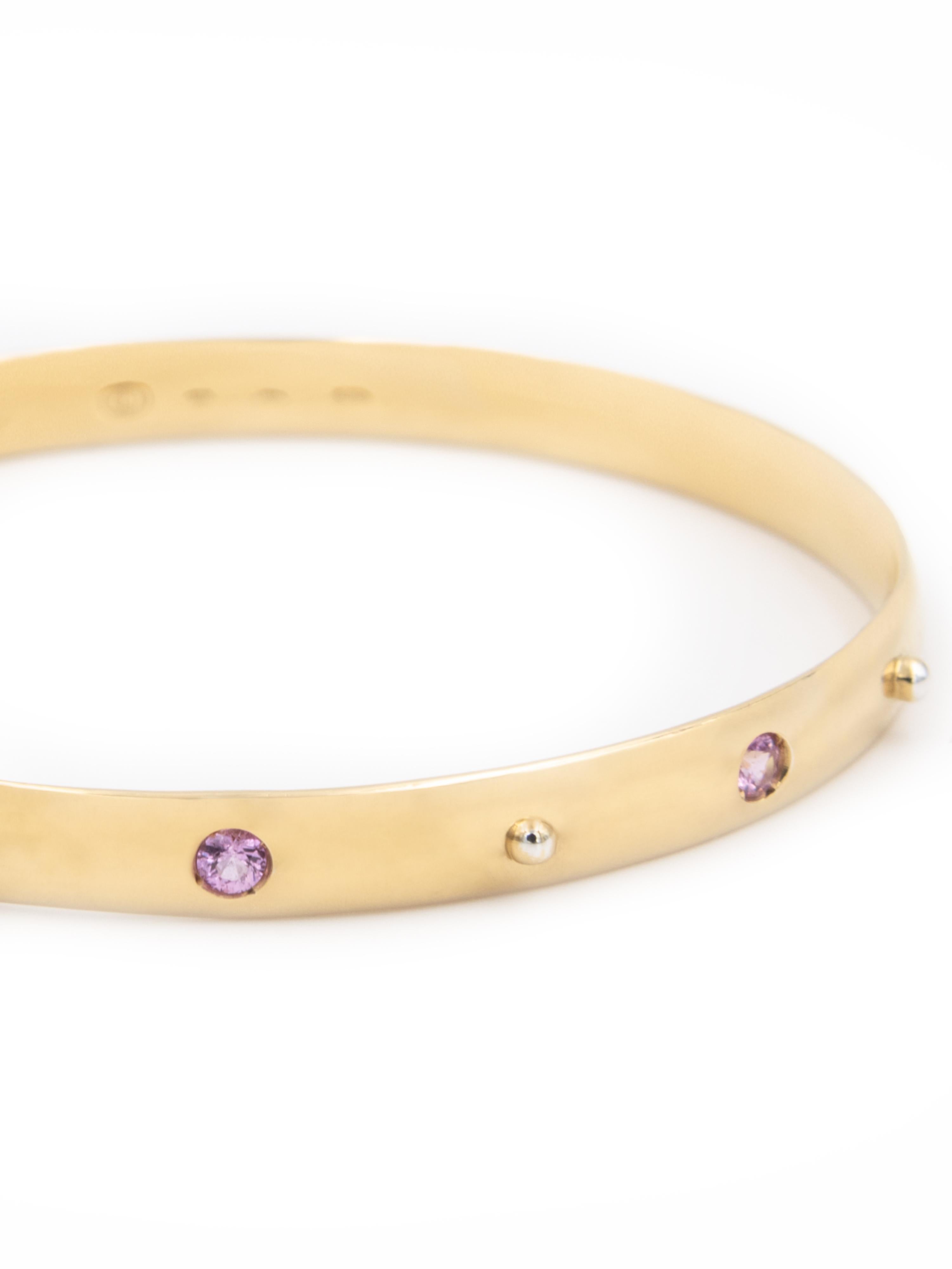 18 karat yellow gold bangle stacking bracelet with 0,3-carat of pink sapphires.  
  
This bracelet is available in a standard diameter of 6,25 cm (2,46 inch), intended to fit most wrists.

Perfect worn alone or for stacking with the other stacking