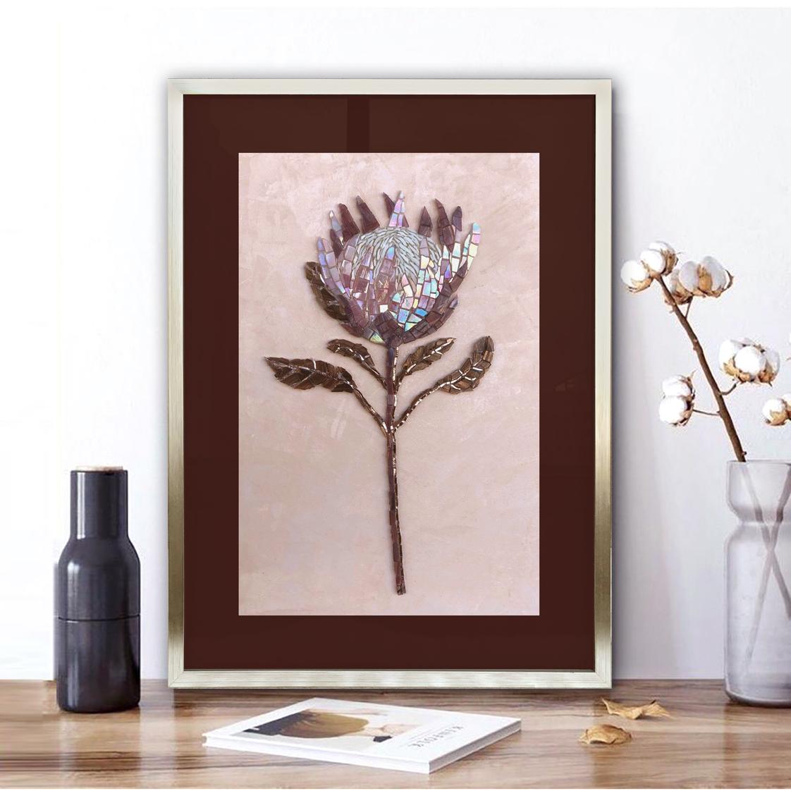 Protea flower in purple glass mosaic with silver inlay.
Deep wooden frame in champagne colour under glass. 
An exotic flower resembling a sweet airy cake wrapped in a bright package with sharp edges.
Vivid but noble home decoration.