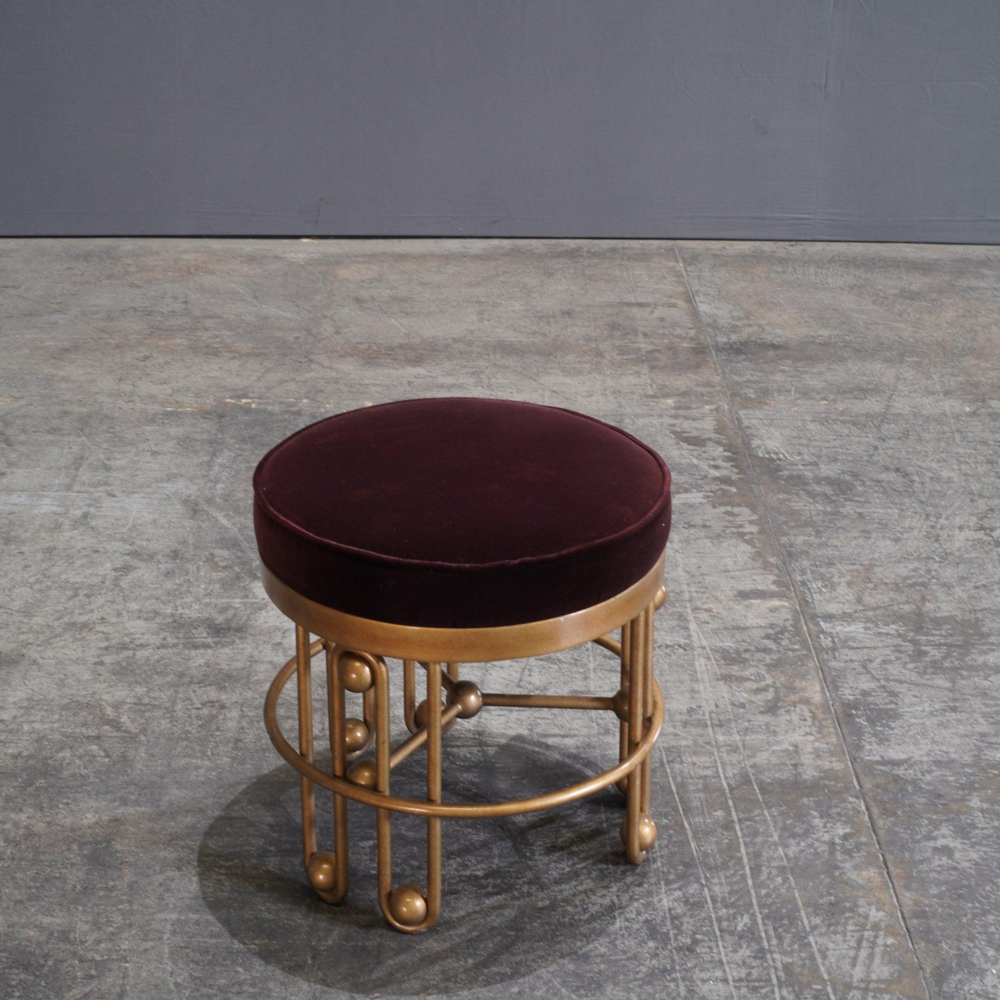 The Julian Chichester Stool in Gold and Aubergine Fabric is a striking piece that effortlessly merges luxury with playful design. The stool features a richly hued aubergine velvet seat that adds a plush, inviting touch, perfectly offset by the