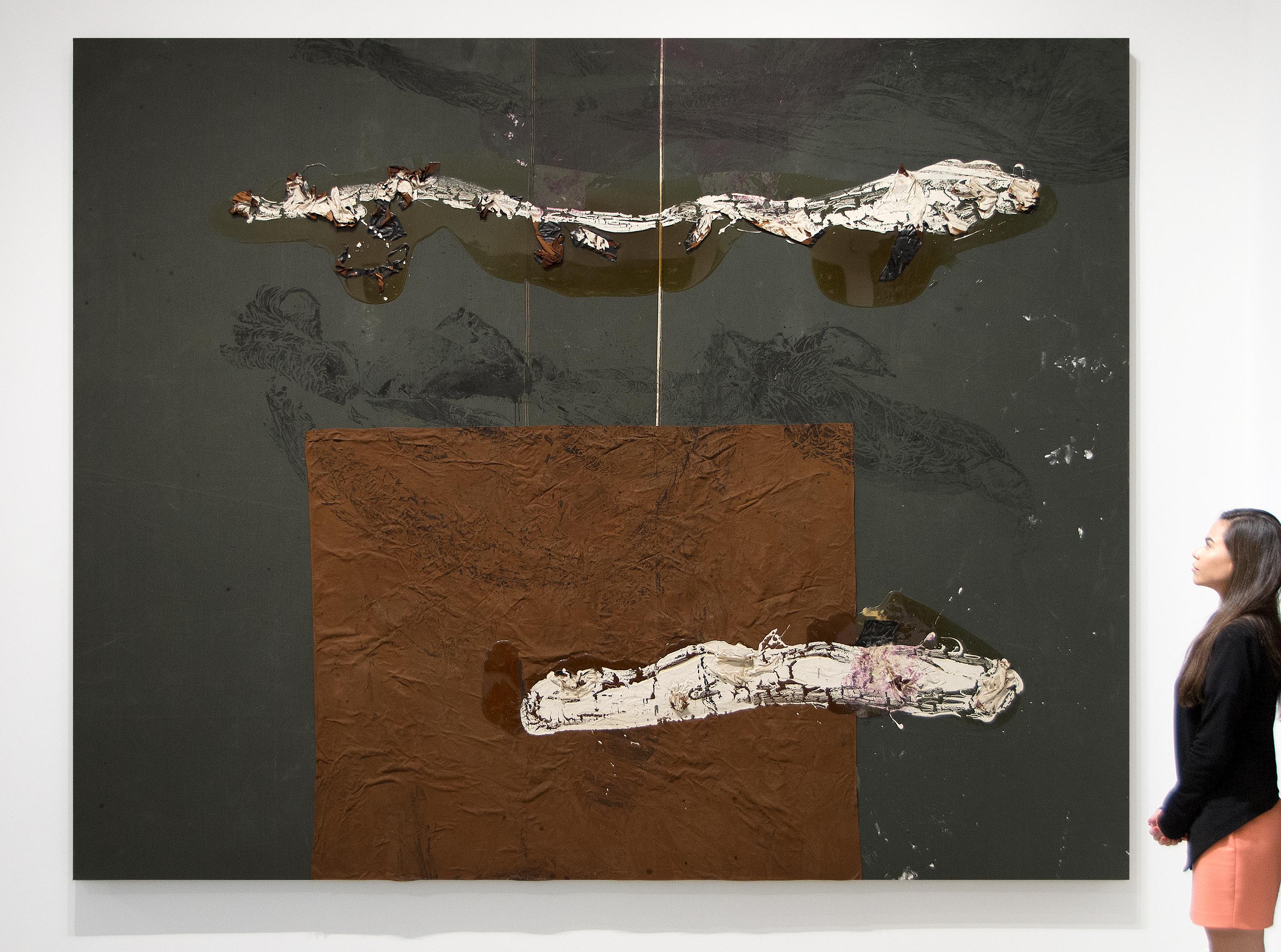 A work by Julian Schnabel. This large scale, Untitled, abstract, oil, resin, gesso, fabric and leather on seamed dropcloth is executed in a dark palette of rust, gray and black with white by contemporary artist Julian Schnabel. Julian Schnabel is