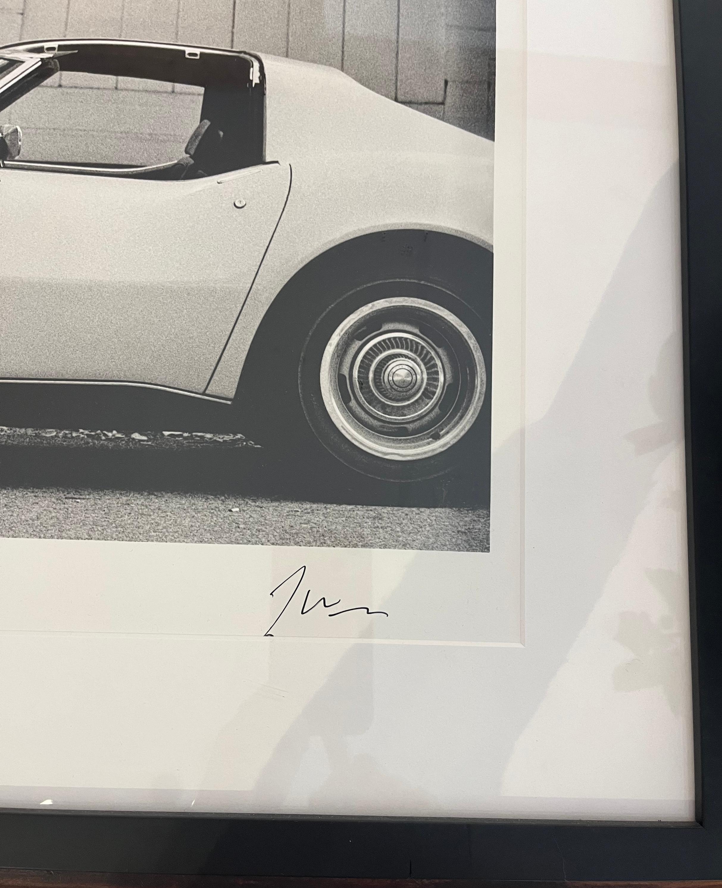 ^Framed^ Joan Didion in front of her Stingray Corvette, 1968 - Edition AP/5 - Photograph by Julian Wasser
