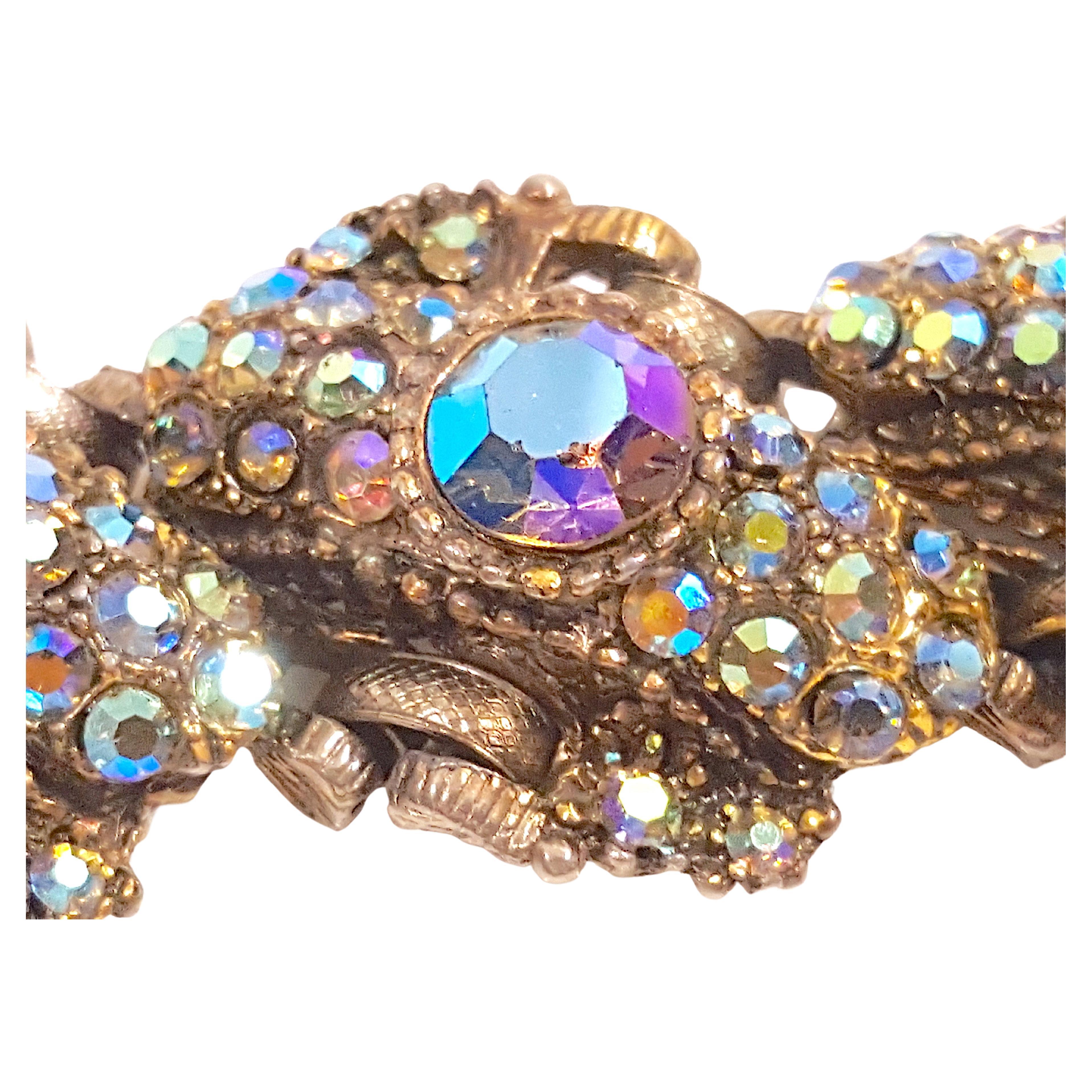 New York City designers Delizza & Elster created this eye-catching sparkly colorful chunky heavy six-link gunmetal bracelet in the late mid-century. It is elaborately encrusted with aurora-borealis (AB) foiled crystals in two sizes all set in open