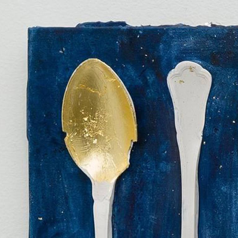 This blue and white mixed media piece was created with a hydrocal cast, vintage cutlery with gold leaf, and indigo ink dye.

Julie Schenkelberg grew up in the post-industrial landscape of Cleveland, Ohio. Her mixed-media installations start with
