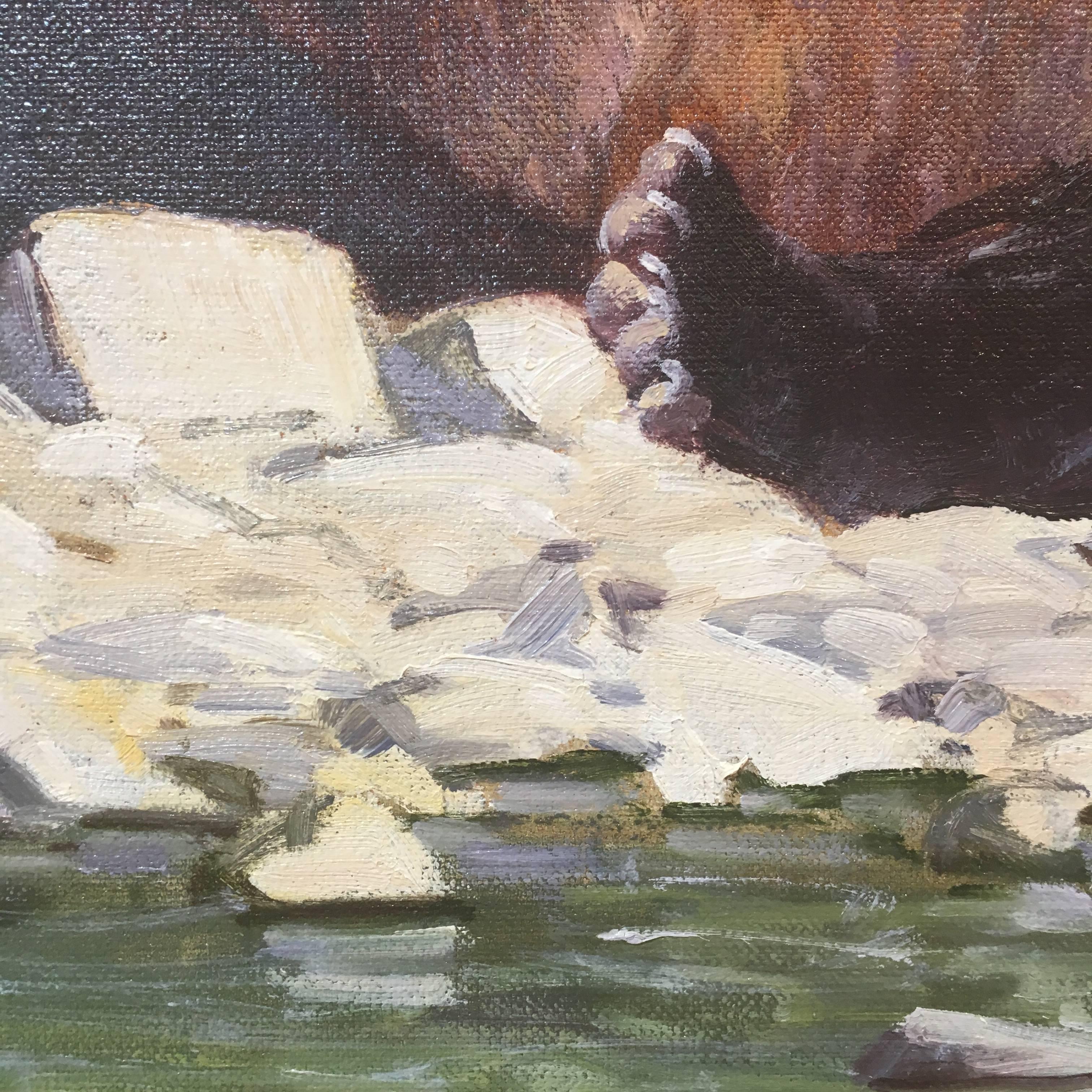 This is an oil painting of two almost matured grizzly bear cubs. They are sitting together on a bed of white rocks by a green river. They are looking compassionately into the sunlight in the upper right hand corner. The background is a blurred