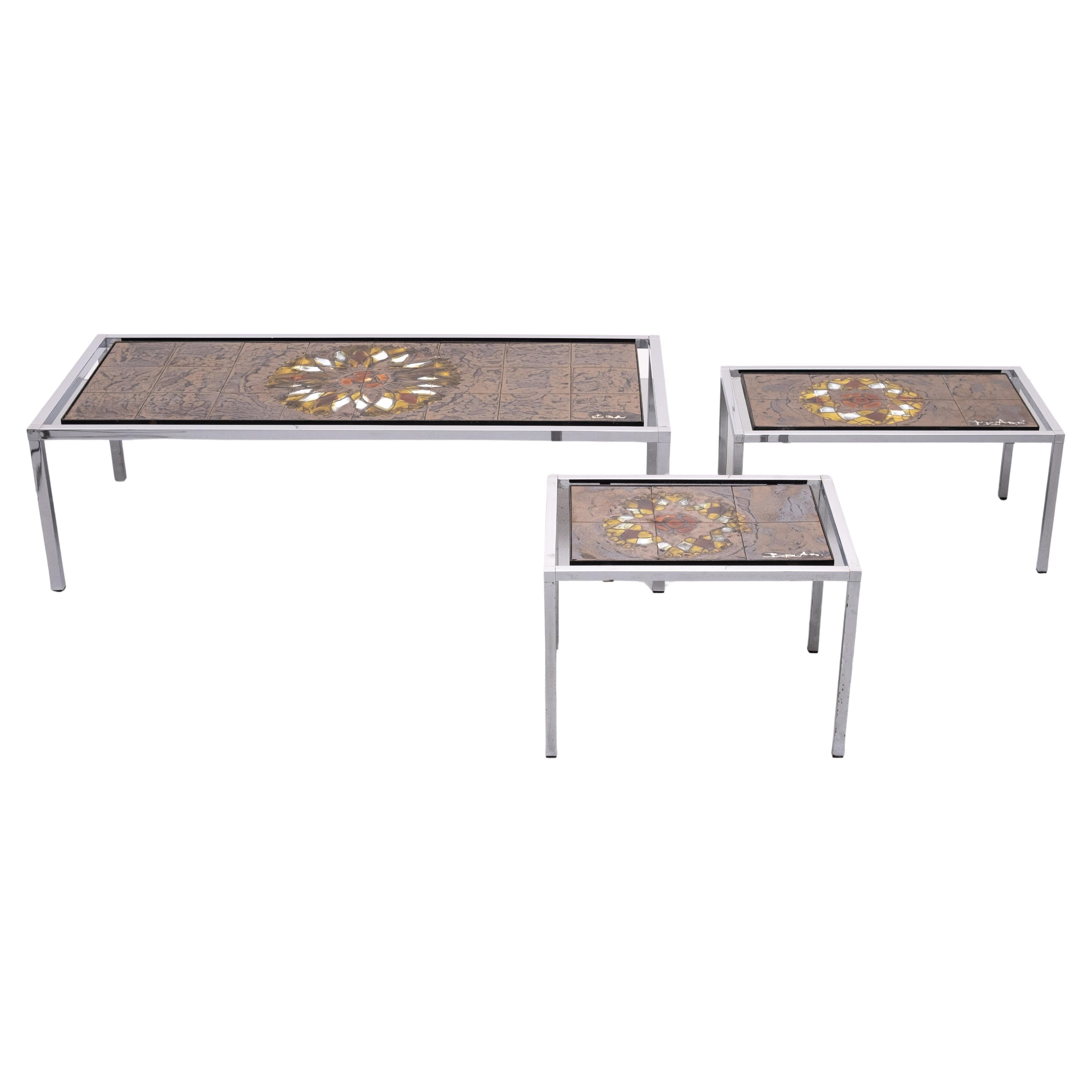 Beautiful set of Three Juliette Belarti Tables . Hand painted decorative Ceramic Tiles . Stunning Abstract decor . Great color . 
The smaller Table has 2 broken tiles and some rust on the legs .
The larger 2 tables are in a good condition . Signed .