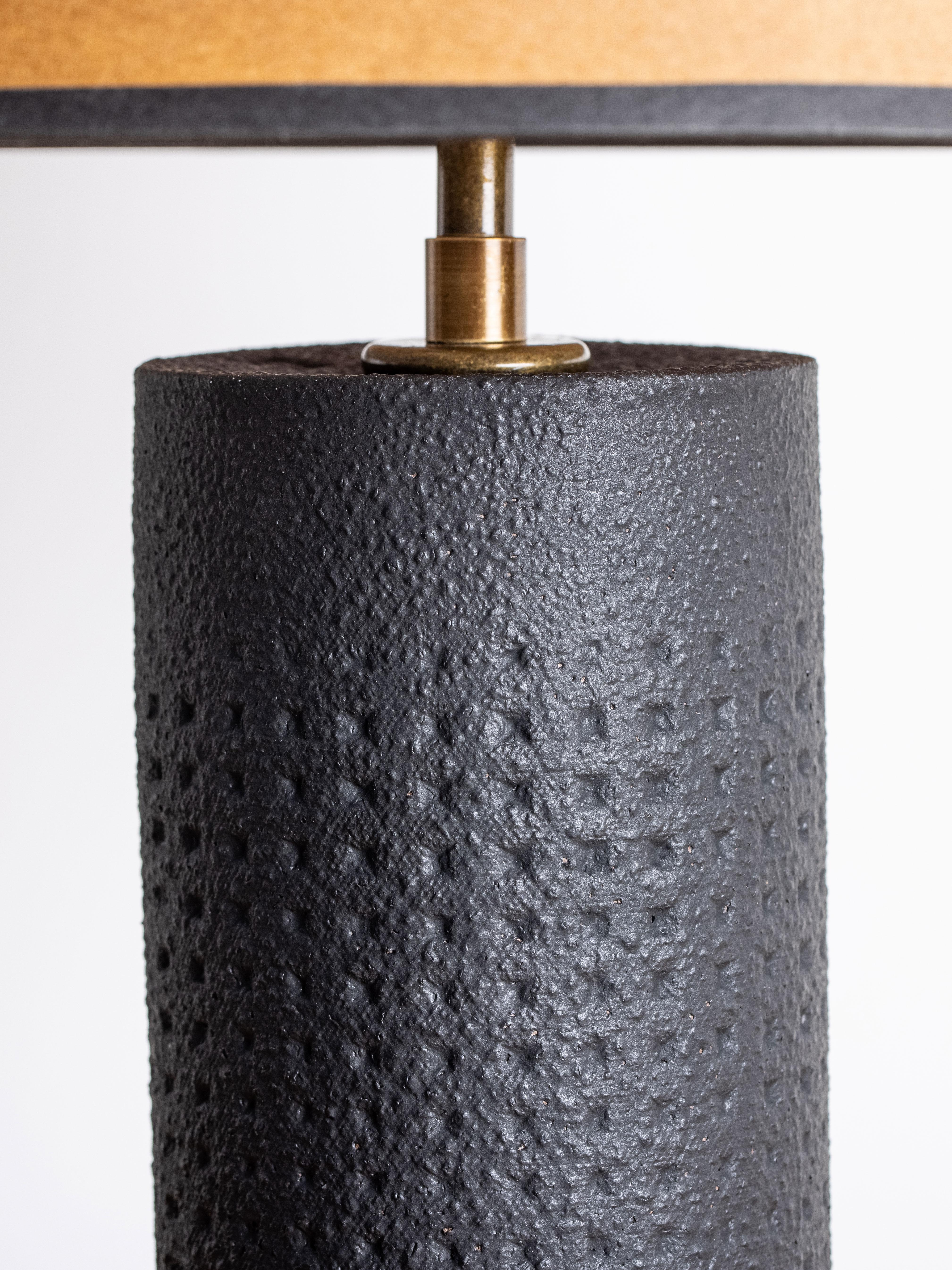 Our stoneware Juliette Lamp is handcrafted using slab-construction techniques. The lamp’s pattern is created by rolling the surface with textured rolling pins and rods.

FINISH

- Matte-black dipped glaze
- Antique brass fittings
- Twisted