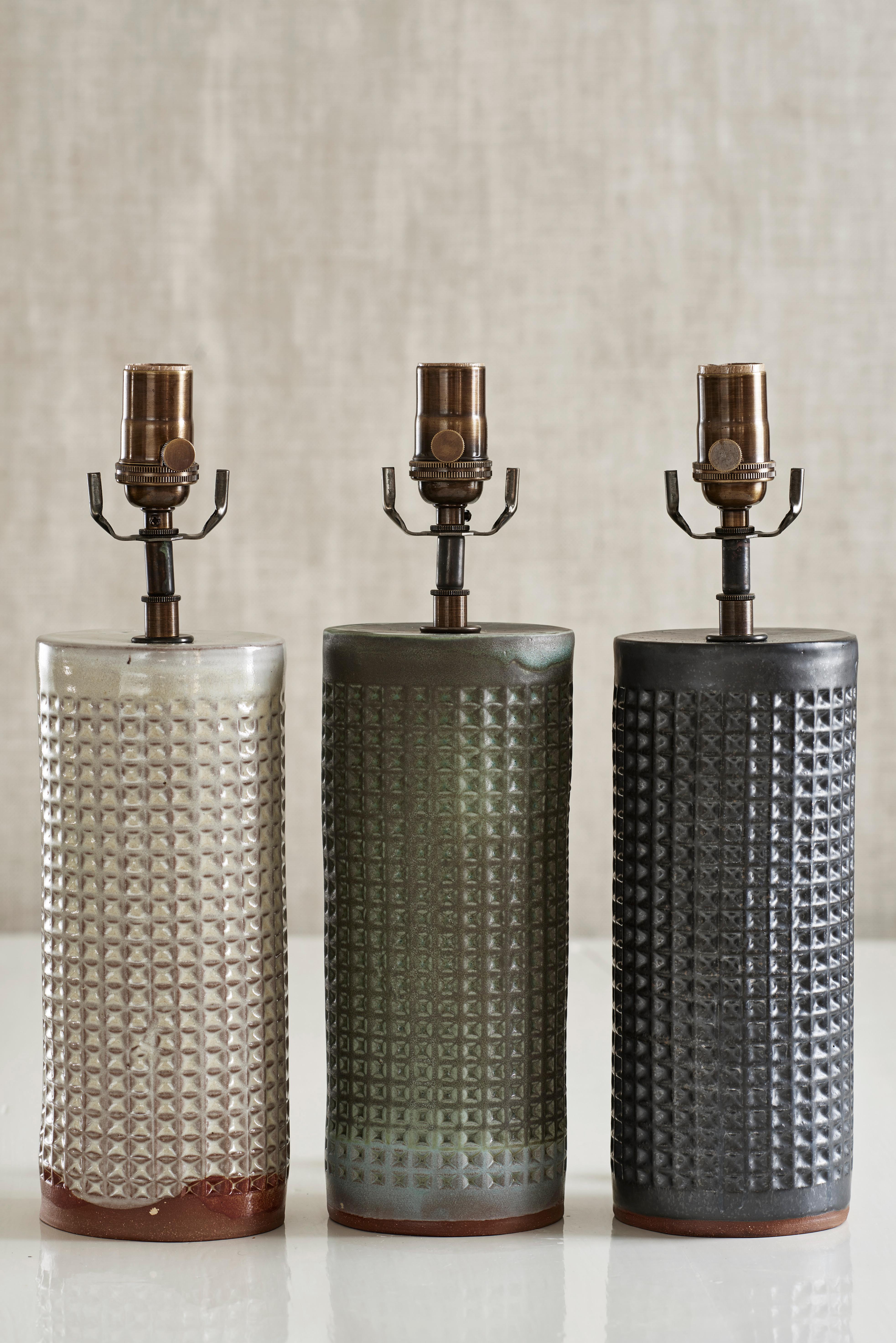 Handmade stoneware slab construction with waffle texture. Lamps are individually crafted and one of a kind.

Verdigris glaze with waffle texture. Antique brass fittings with braided black silk cord and black linen shade.

Measures: Column height