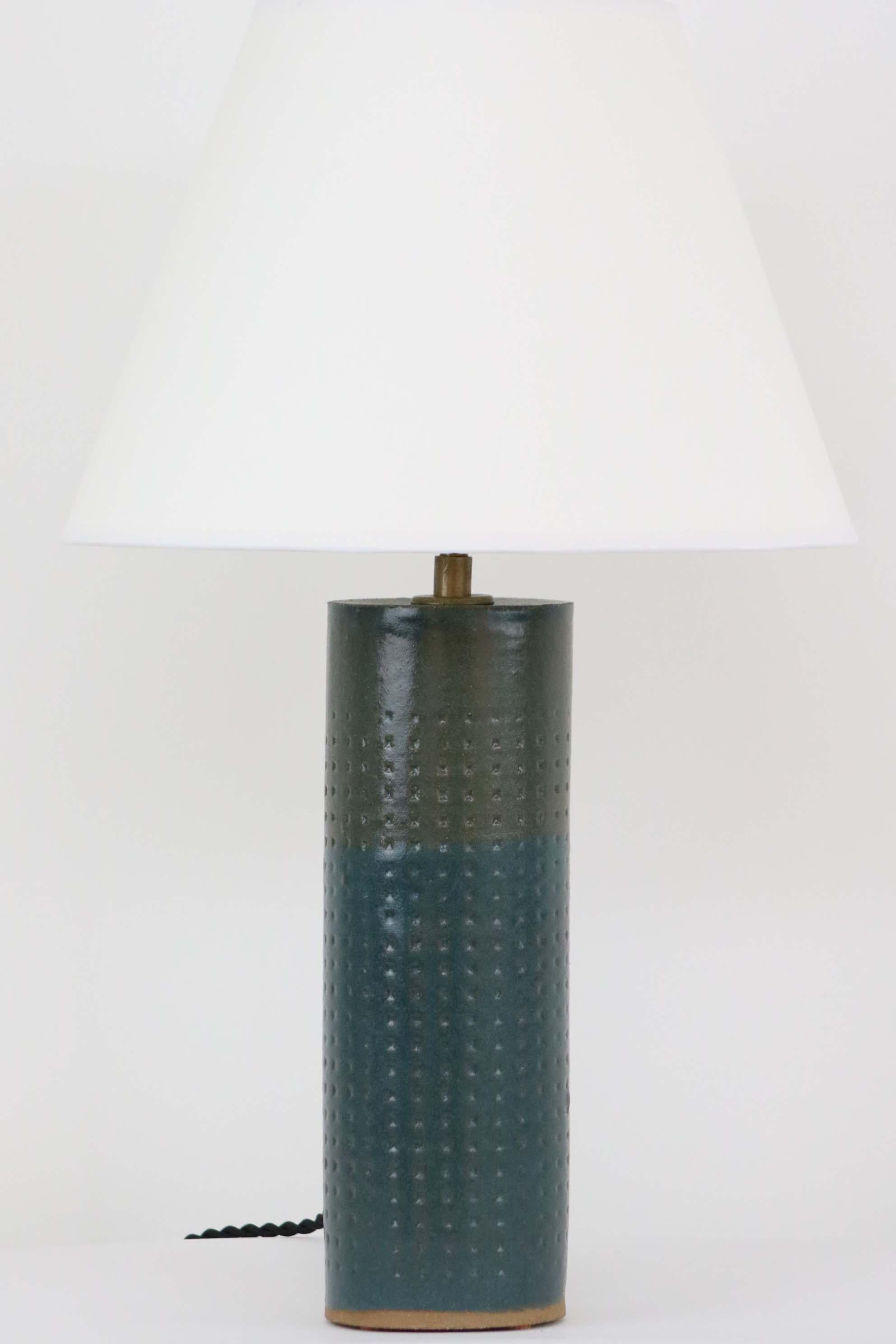 Our stoneware Juliette lamp is handcrafted using slab-construction techniques. The lamp’s pattern is created by rolling the surface with textured rolling pins and rods.

Finish

- Dipped glaze, pictured in Cerulean
- Antique brass fittings
-