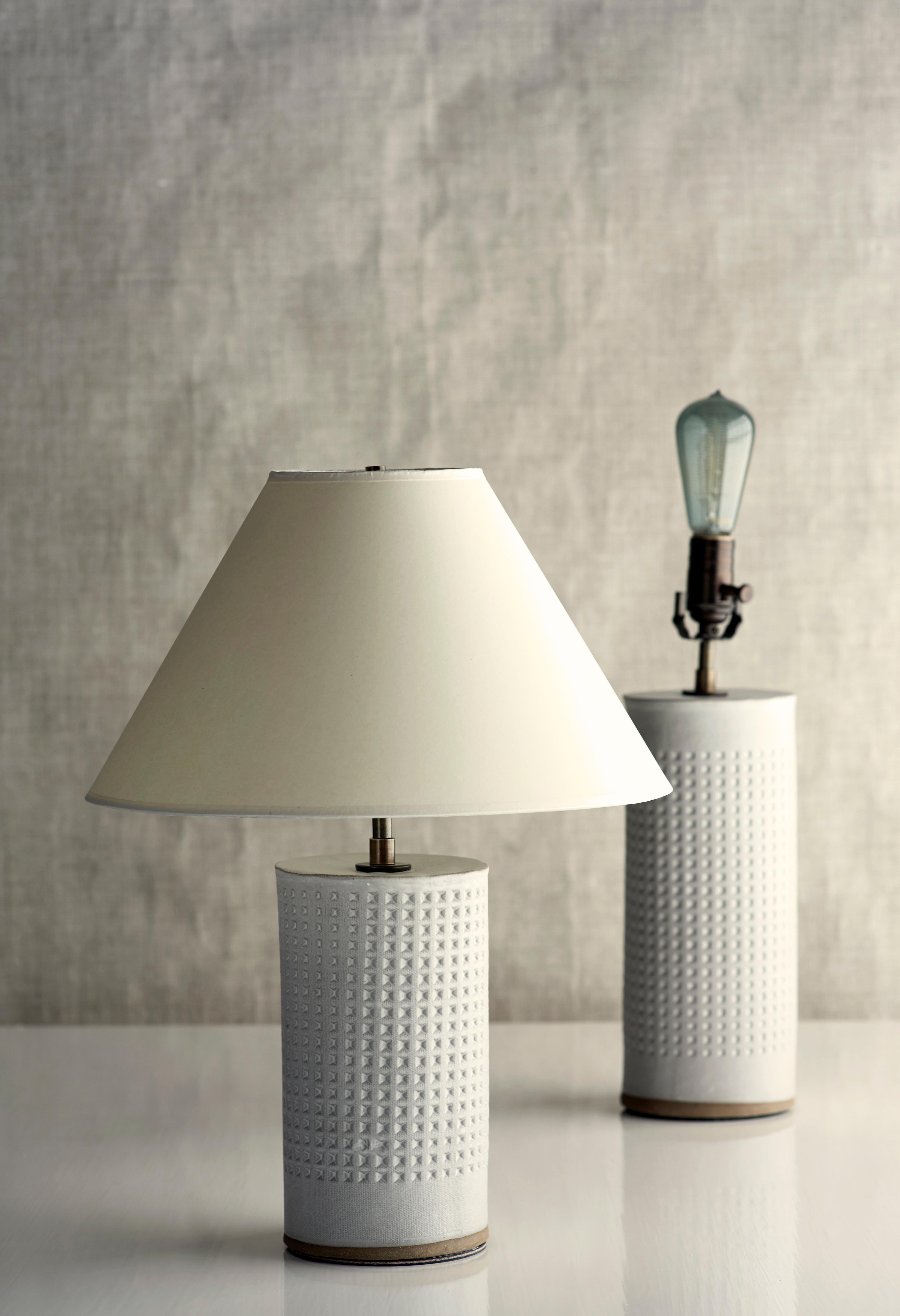 DESCRIPTION

Handmade stoneware slab construction with waffle texture. Lamps are individually crafted and one of a kind.

FINISH

Chalk White glaze with waffle texture. Antique brass fittings with dimmer switch on socket. Braided black cloth cord