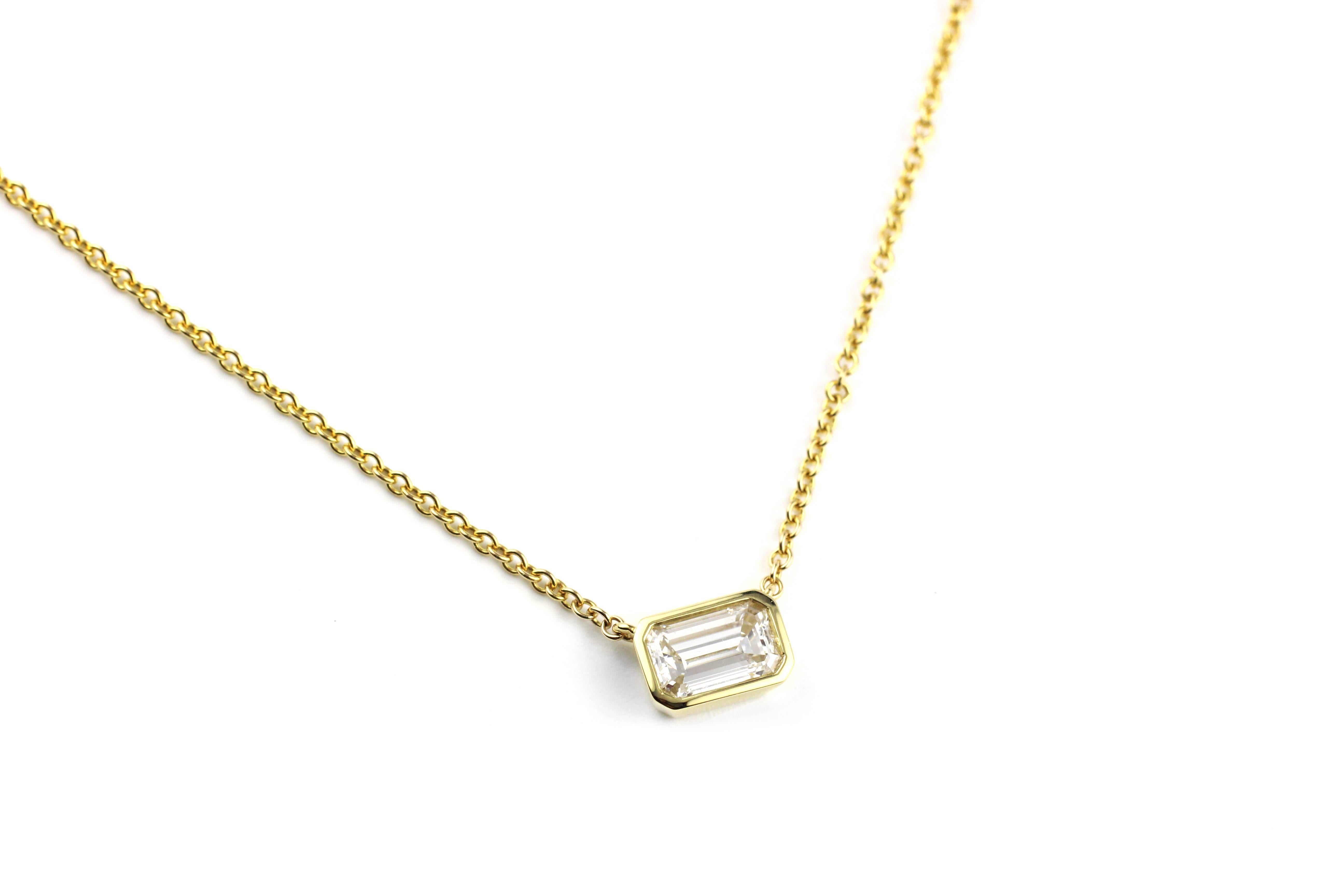 This elegant sparkler contains 1 very fine 1.08 Ct. Emerald Cut Diamond, GIA Certified D VS - 1.  A beautiful and bright stone set in a simple, modern 18 Kt Gold bezel.  Versatile and lovely. 

16 inch long, 18 Kt Gold chain.  

Designed and made