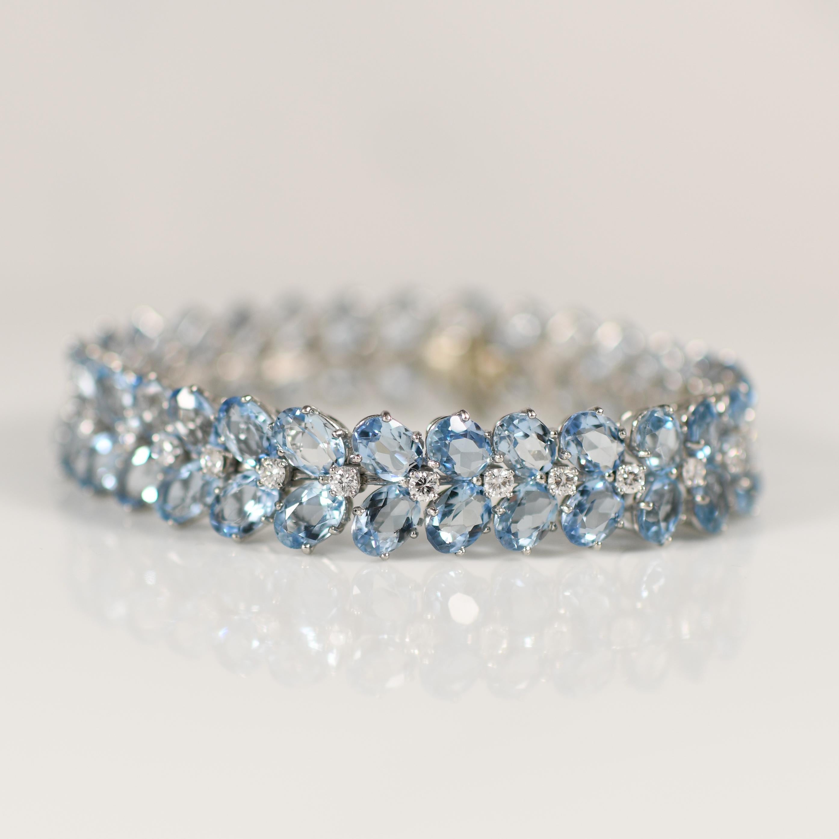 Exuding opulence and sophistication, the 18k white gold Julius Cohen bracelet showcases over 20 carats of breathtaking aquamarine gemstones accented with sparkling diamonds. Each aquamarine, renowned for its serene blue hue reminiscent of the ocean,