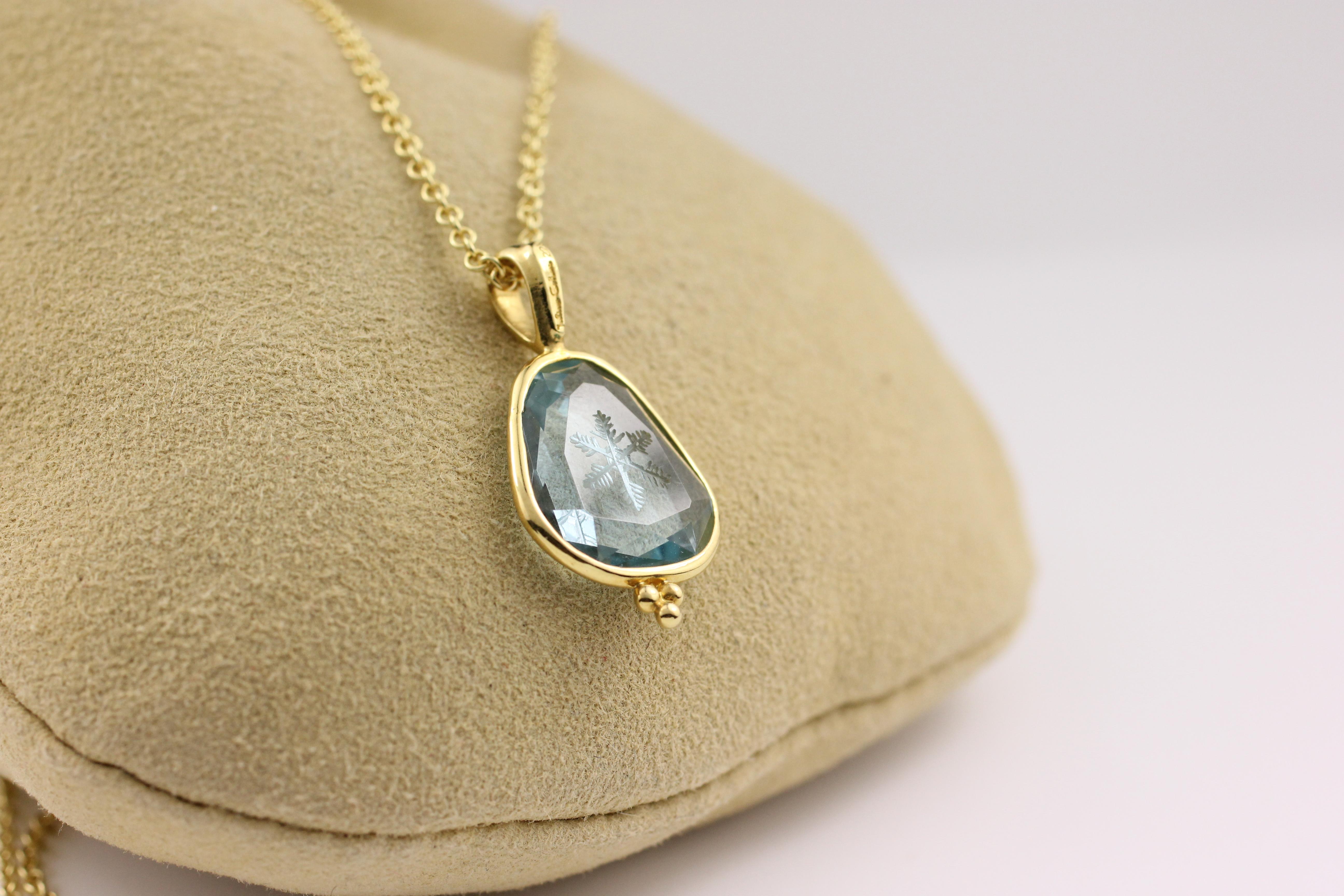 This one-of-a-kind pendant necklace features a beautiful, clear, icy blue Aquamarine (4.10 Cts.) The stone has a hand-carved snowflake at its center, made by the finest artisans in Idar-Oberstein, Germany-- renowned for their fine stone craft.  The