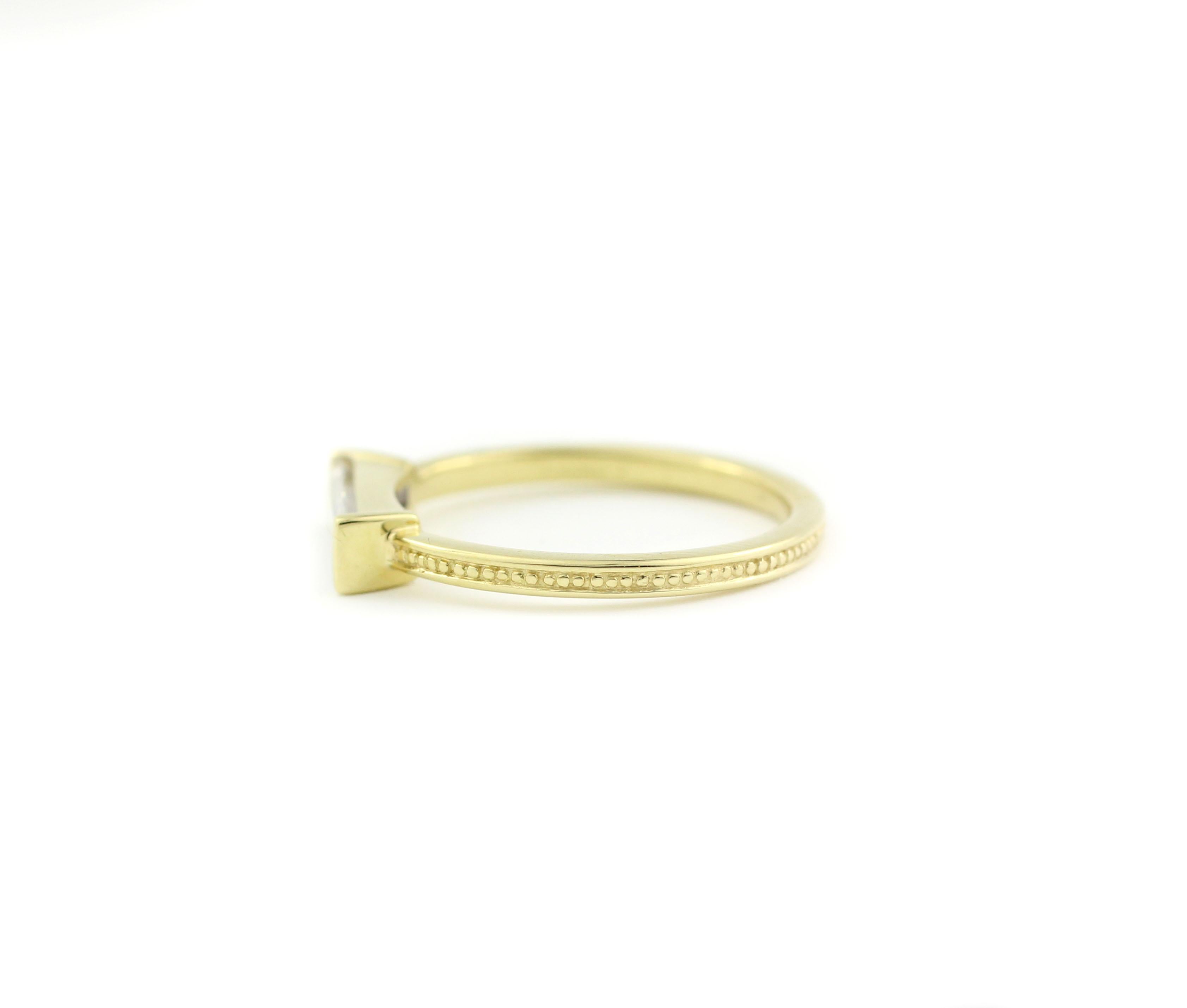 18 Kt Yellow Gold and Baguette Diamond Ring

This unique ring blends the ancient style of a finely beaded band detail with the modern setting of one long, baguette Diamond (10.3mm x 3mm).  This clear and unusually cut Diamond weighs .54 Cts. and is