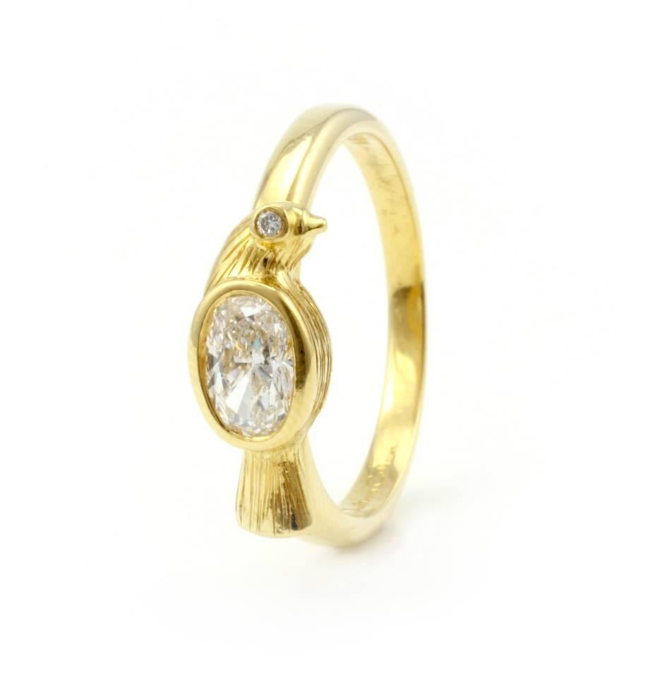 A perennial favorite, this classic 18 Kt Gold Julius Cohen Bird Ring contains one GIA Certified, .48 Ct. Oval Diamond (D, VS-2).  It also has one tiny brilliant diamond for the twinkle in the bird's eye.  
Currently size 6 1/2, but can be sized to