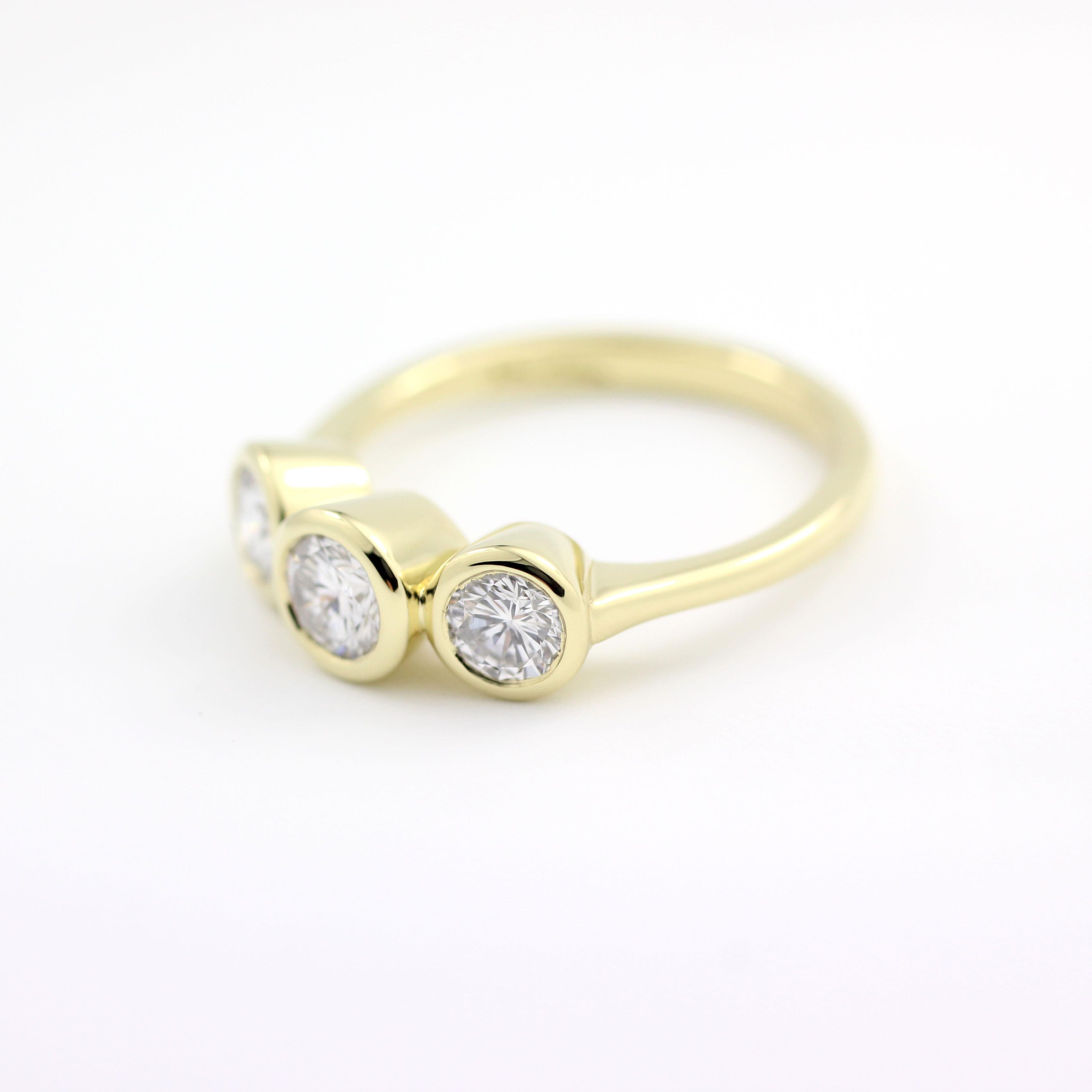 This ancient/modern, three-stone 18 Kt Gold Ring contains one Brilliant Round Diamond (.34 Cts.) flanked by two slightly smaller Brilliant Round Diamonds (.53 Cts. for both).

In-stock Size 6 1/2 for immediate delivery.

This ring can be sized to