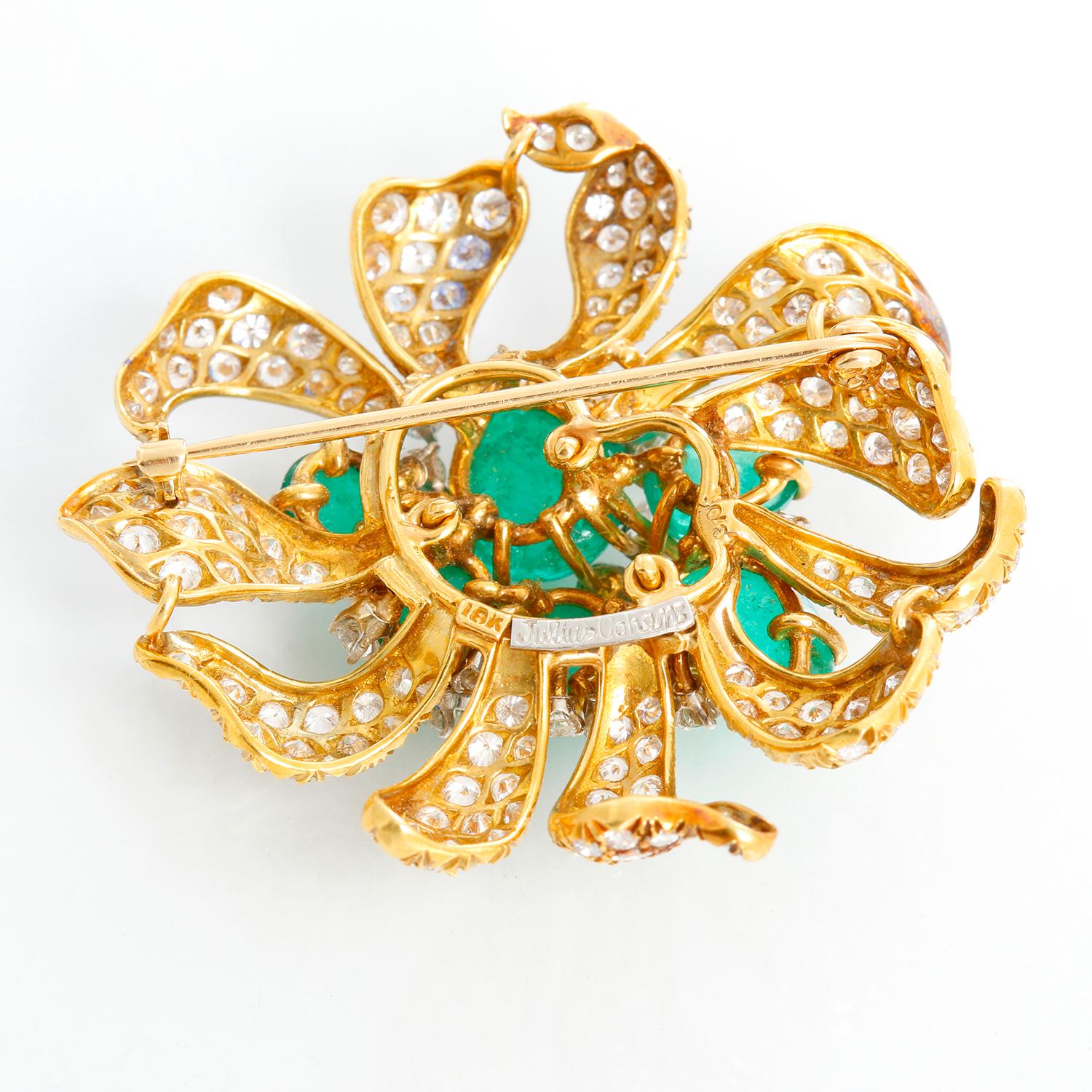 Julius Cohen Emerald and Diamond Estate Pin - 18K yellow gold flower pin, weighing 5 carats of diamonds and 5 carats of cabochon emeralds in pear and oval shapes. Measures 1 3/4 inch at its widest. 

Signed by Julius Cohen who worked for Oscar