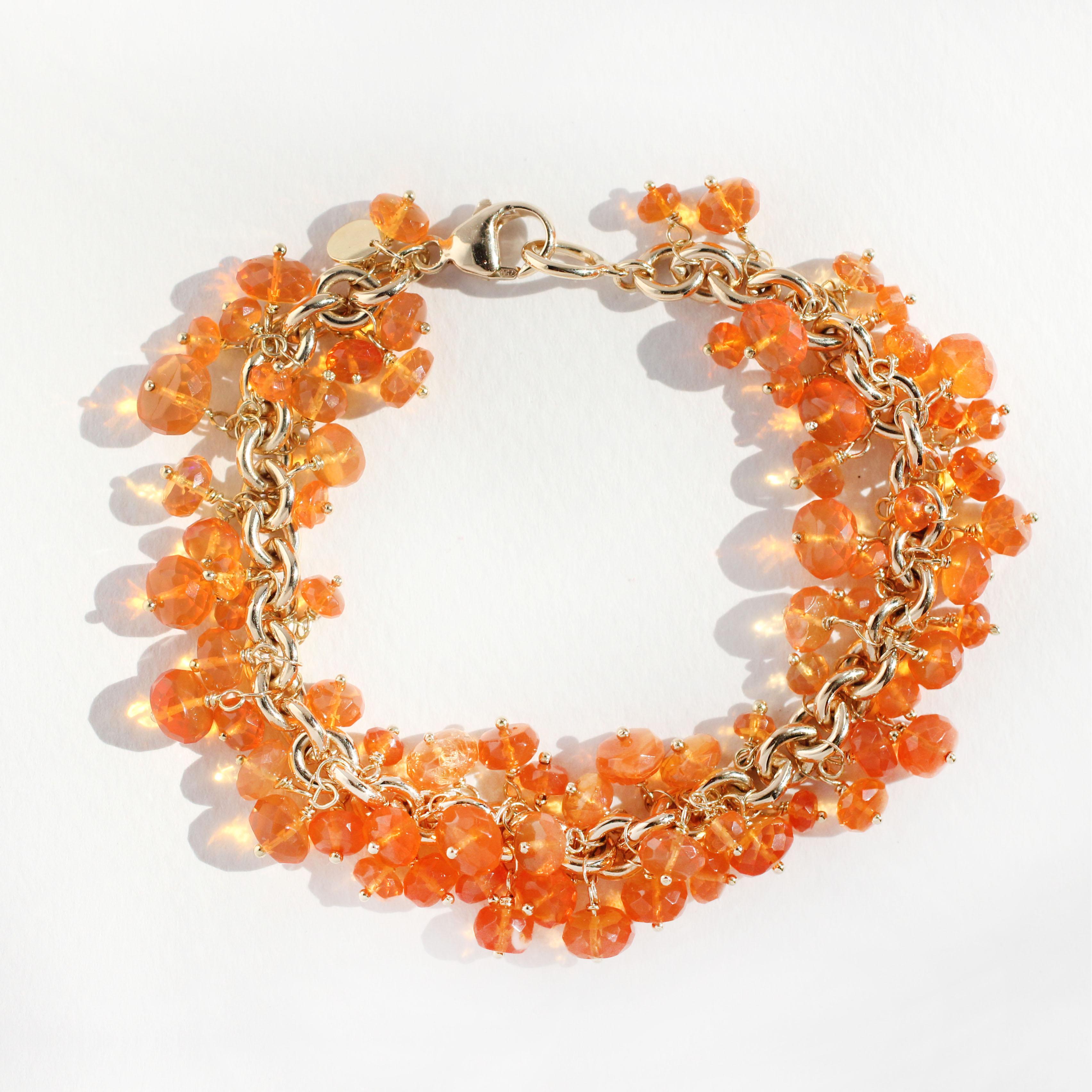 This fringe bracelet contains 76 stunning Mexican Fire Opals (178 Cts.)  Strikingly beautiful, the vivid orange Fire Opal is said to stir up passion and creativity.  Each gem dangles freely on its solid 18 Kt Gold Chain Bracelet.  Secure